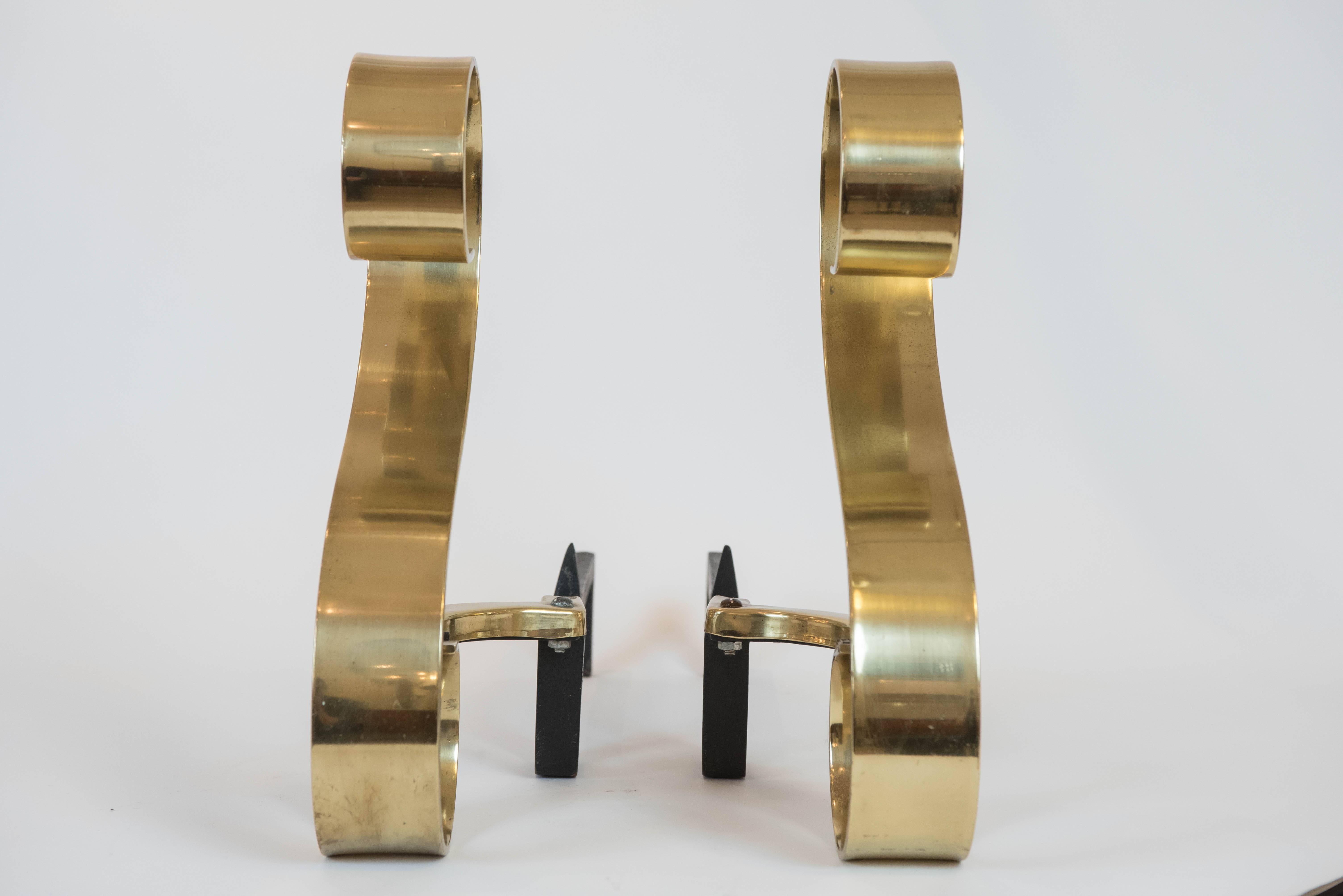 This brilliant and simple pair of solid brass andirons in an 