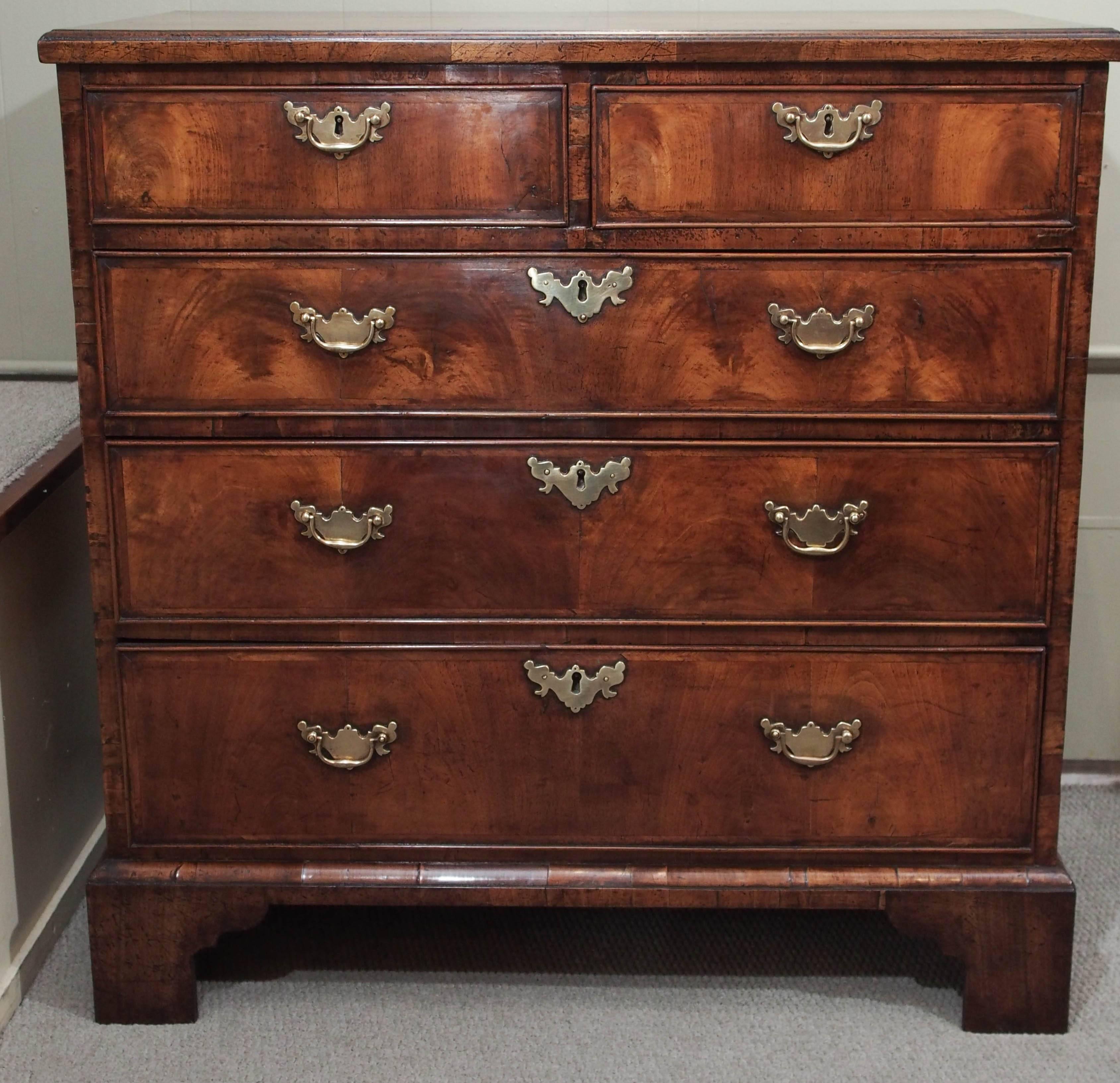 Early 18th century walnut chest of drawers, circa 1730. Crossbanded top and sides.