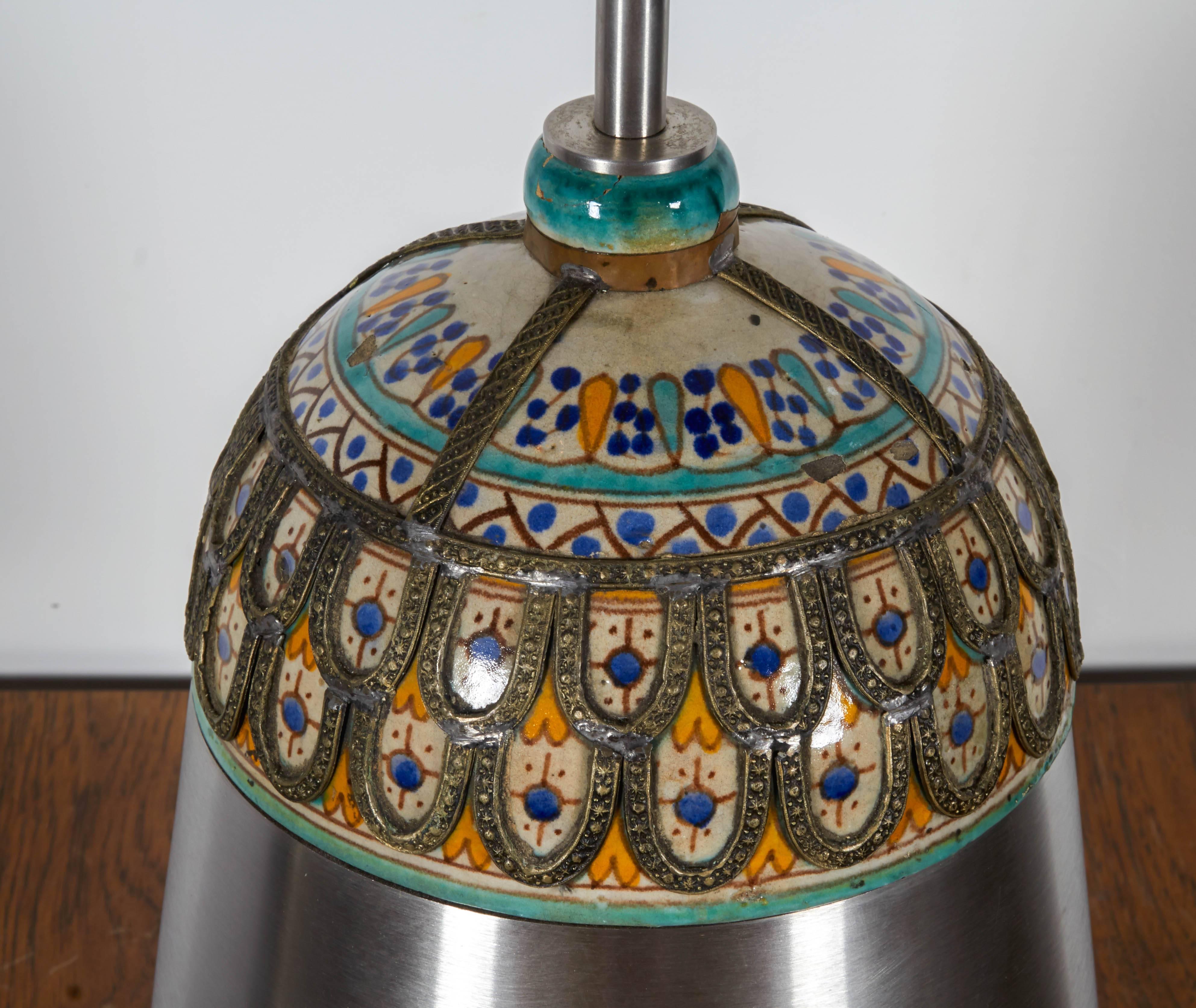 Pair of unusual Moroccan style ceramic and brushed chrome table lamps. Lamps are similar but not identical and feature different tops where design meets hardware.