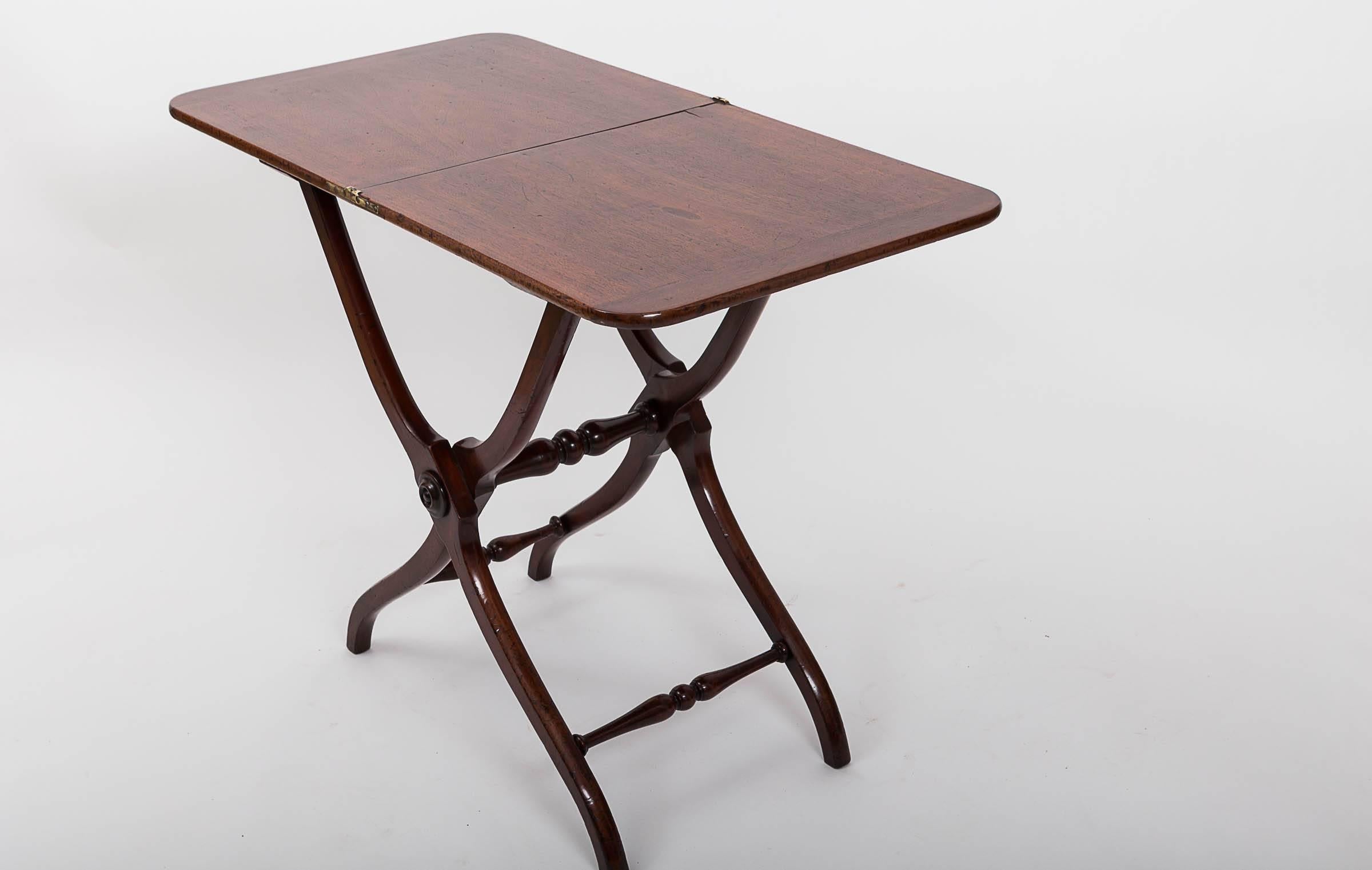 Original folding coaching table with turned stretchers, banded ends on top, splayed leg base, original brass hinges.