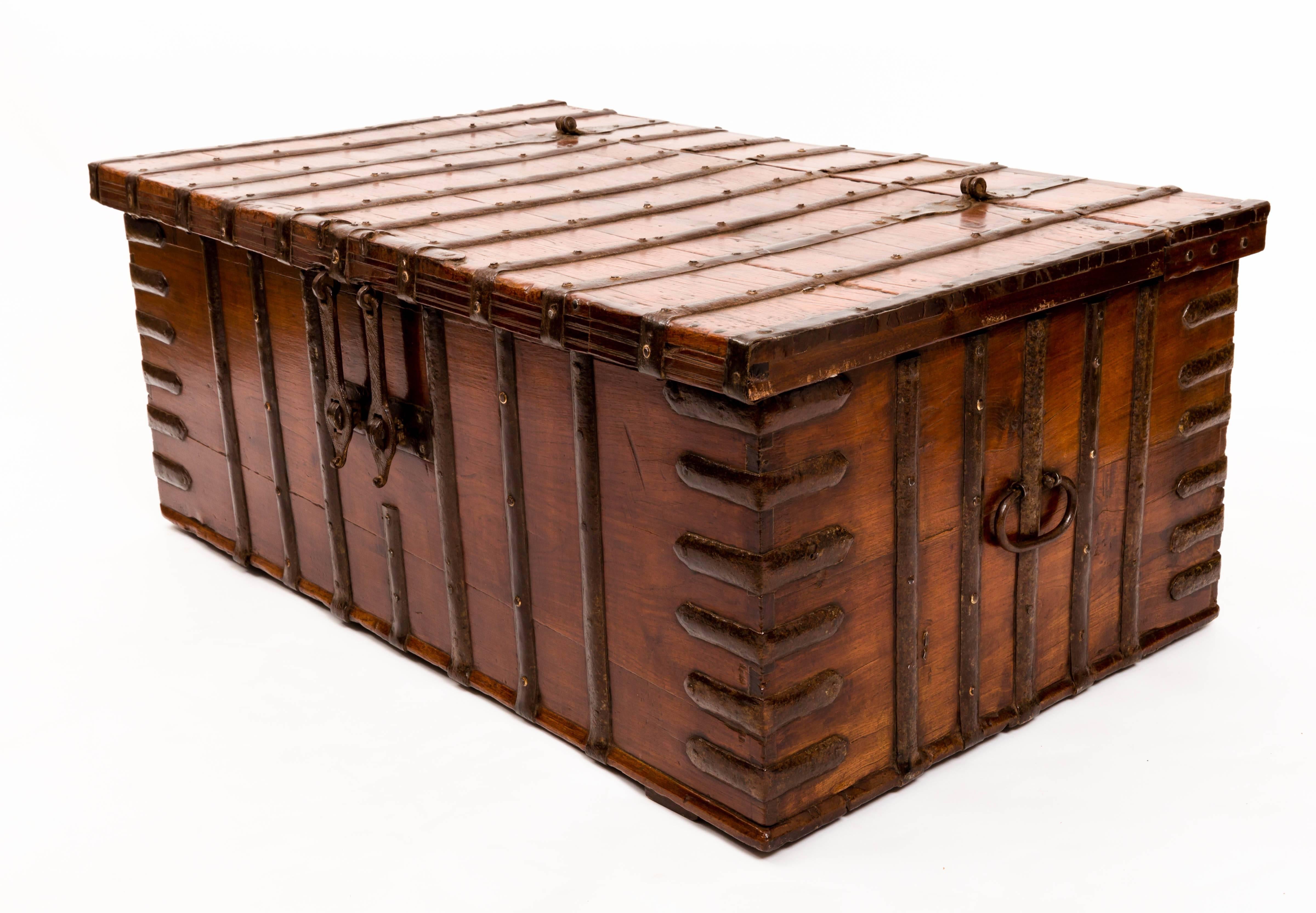 Iron-bound trunk with original iron carrying handles, hinges and double clasps. Good coffee table height.