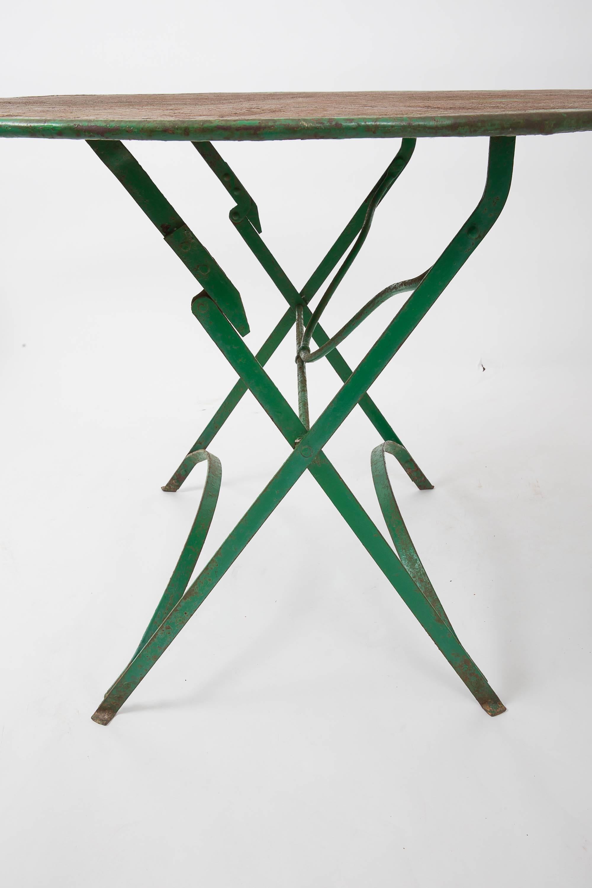 Folding iron table with traces of original paint.