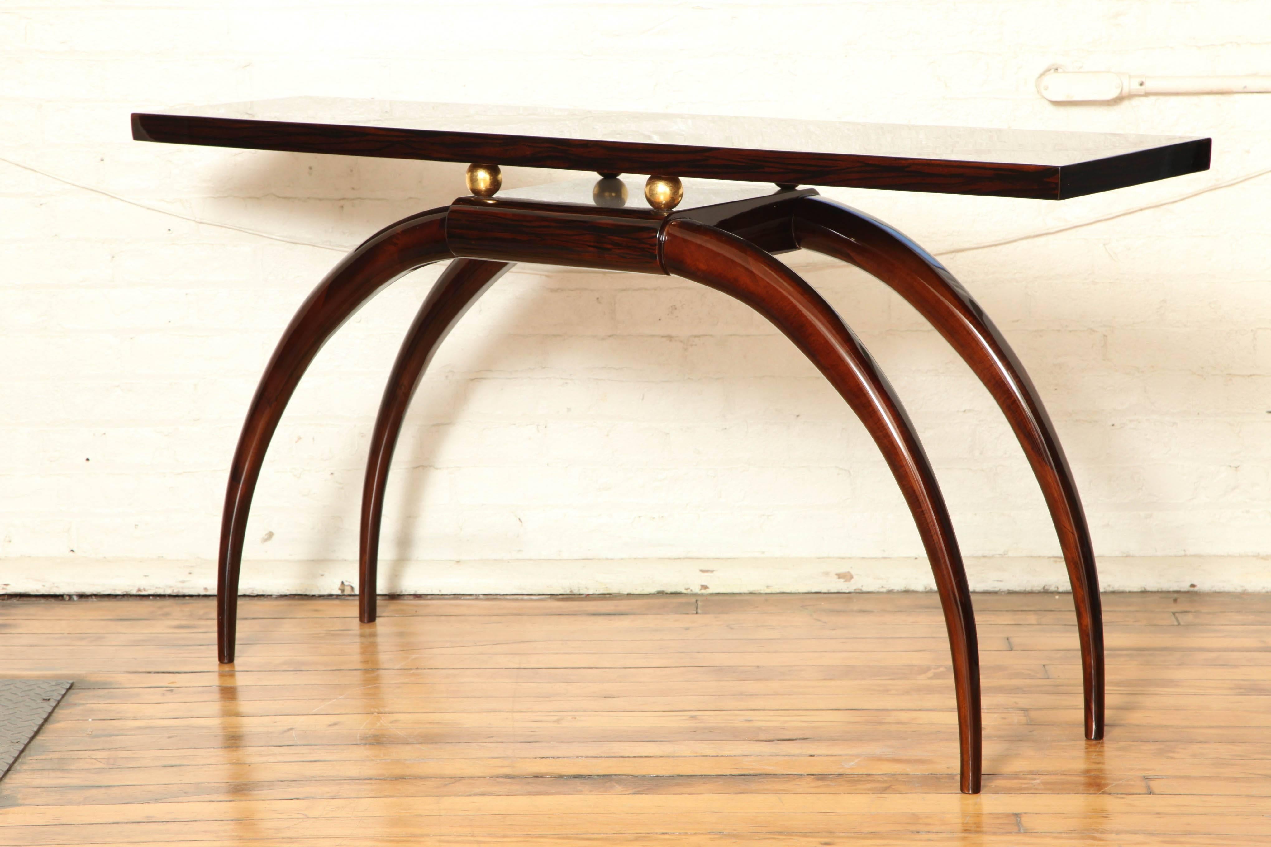 An Art Deco console table. Ziricotta with brass.