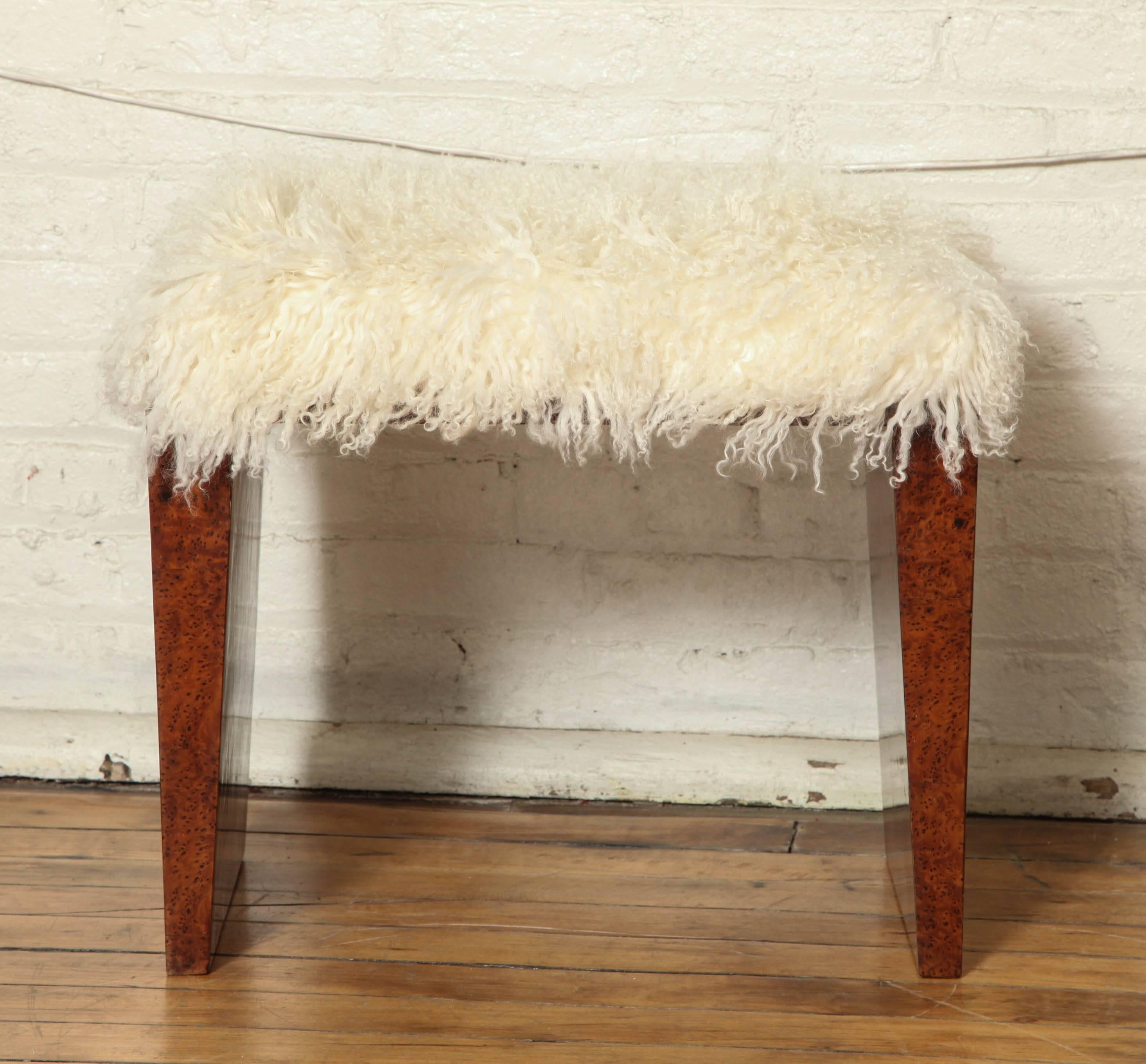 An Art Deco settee /pouf in exotic bubinga wood with Mongolian lamb upholstery.