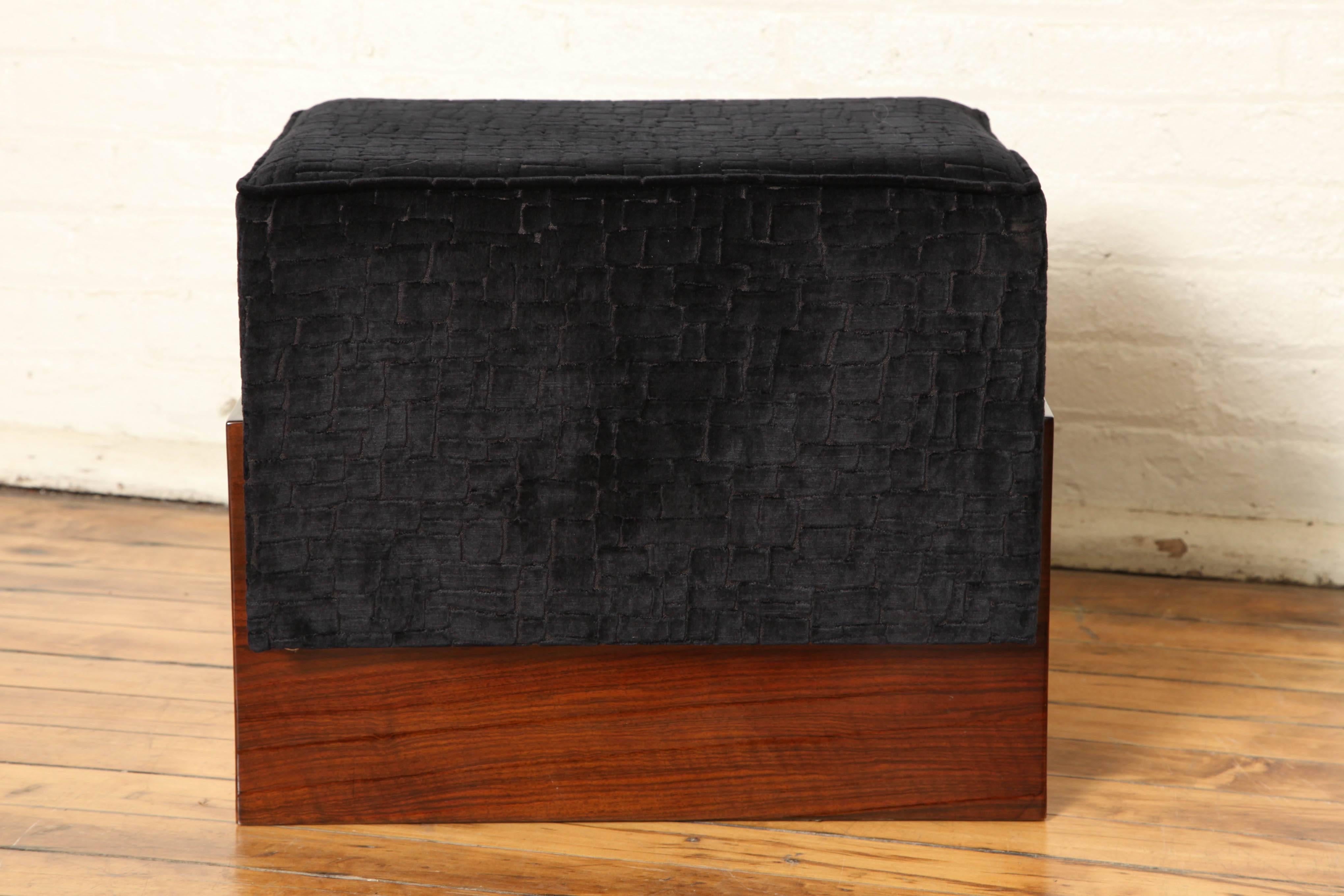 An Art Deco ottoman/pouf in a walnut root frame, newly upholstered in an elegant tone sur tone black velvet.