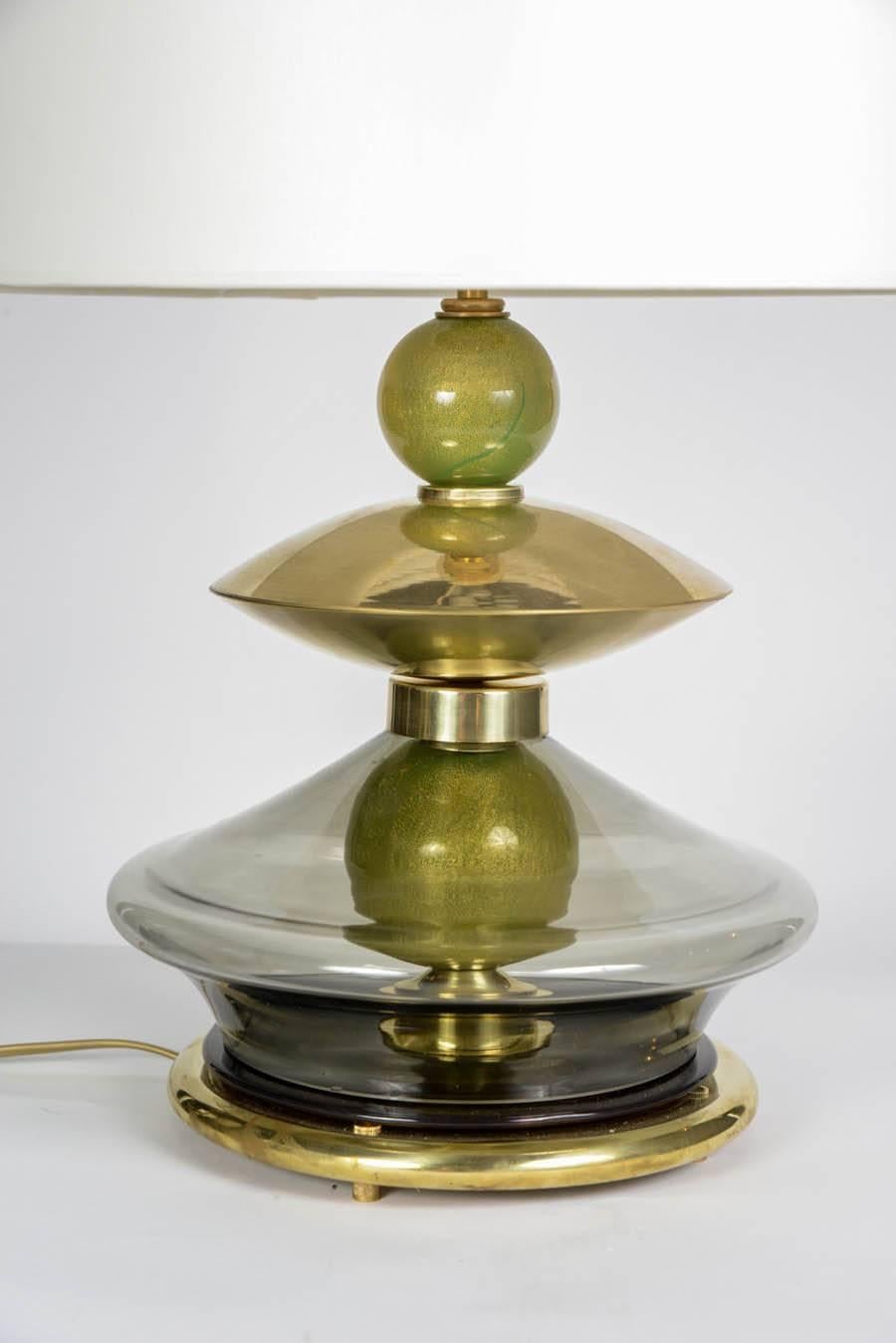 Elegant pair of lamps made of green Murano elements, brass feet and settings.

New electrification, perfect condition.