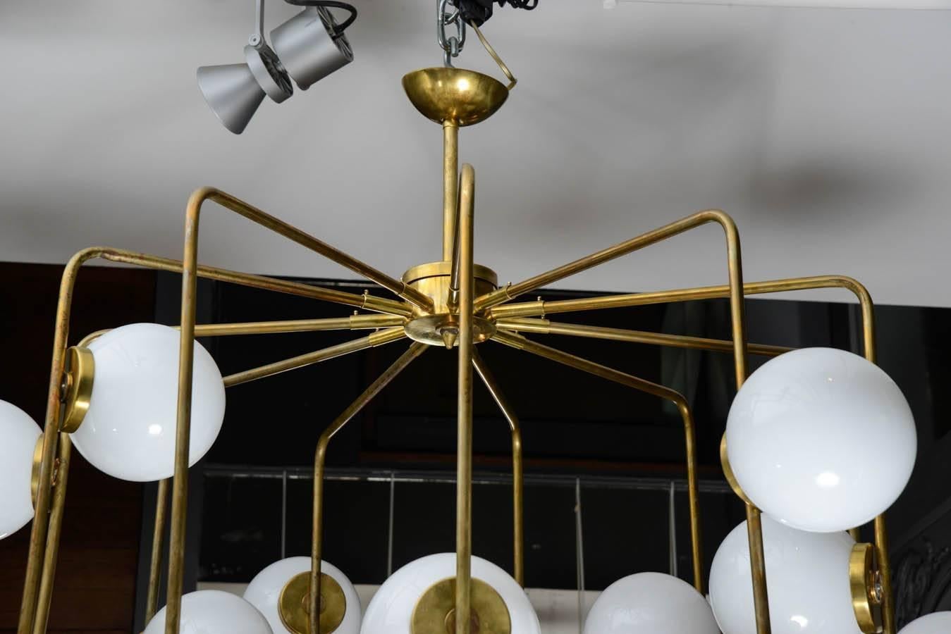 Nice big chandelier made of brass and white glass globes.

The chandelier has an original antic lantern shape, completed by twenty two globes.

Designed by Galerie Glustin Luminaires.