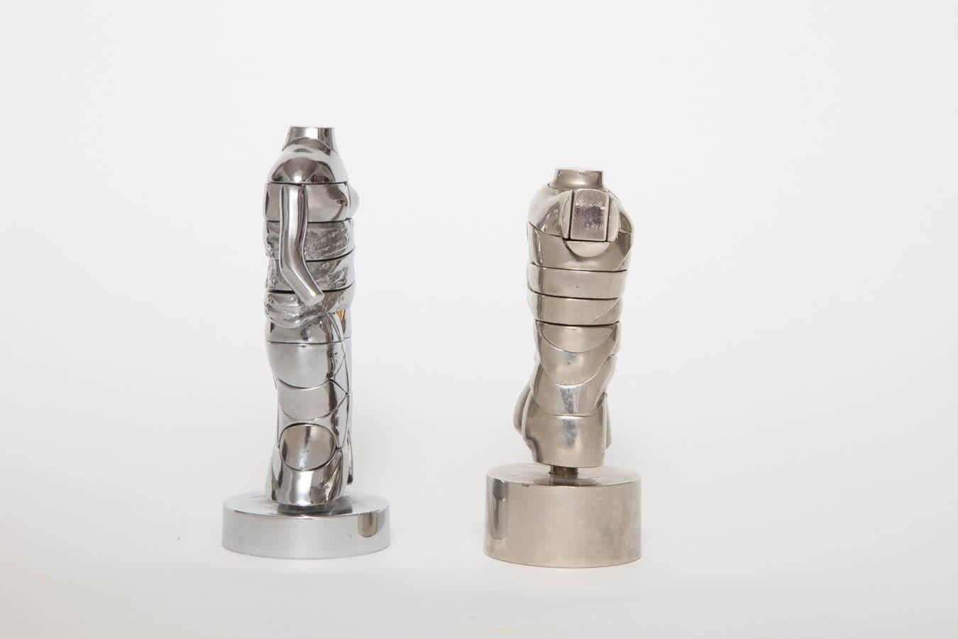 A Pair of Mini Puzzle Sculptures by Spanish artist Miguel Berrocal,1968.
Le Mini David and Le Mini Cariatide, interlocking pieces made of Nickel Plated Brass and Brass. Each accompanied with it's own hardcover instructional book in Mint Condition.