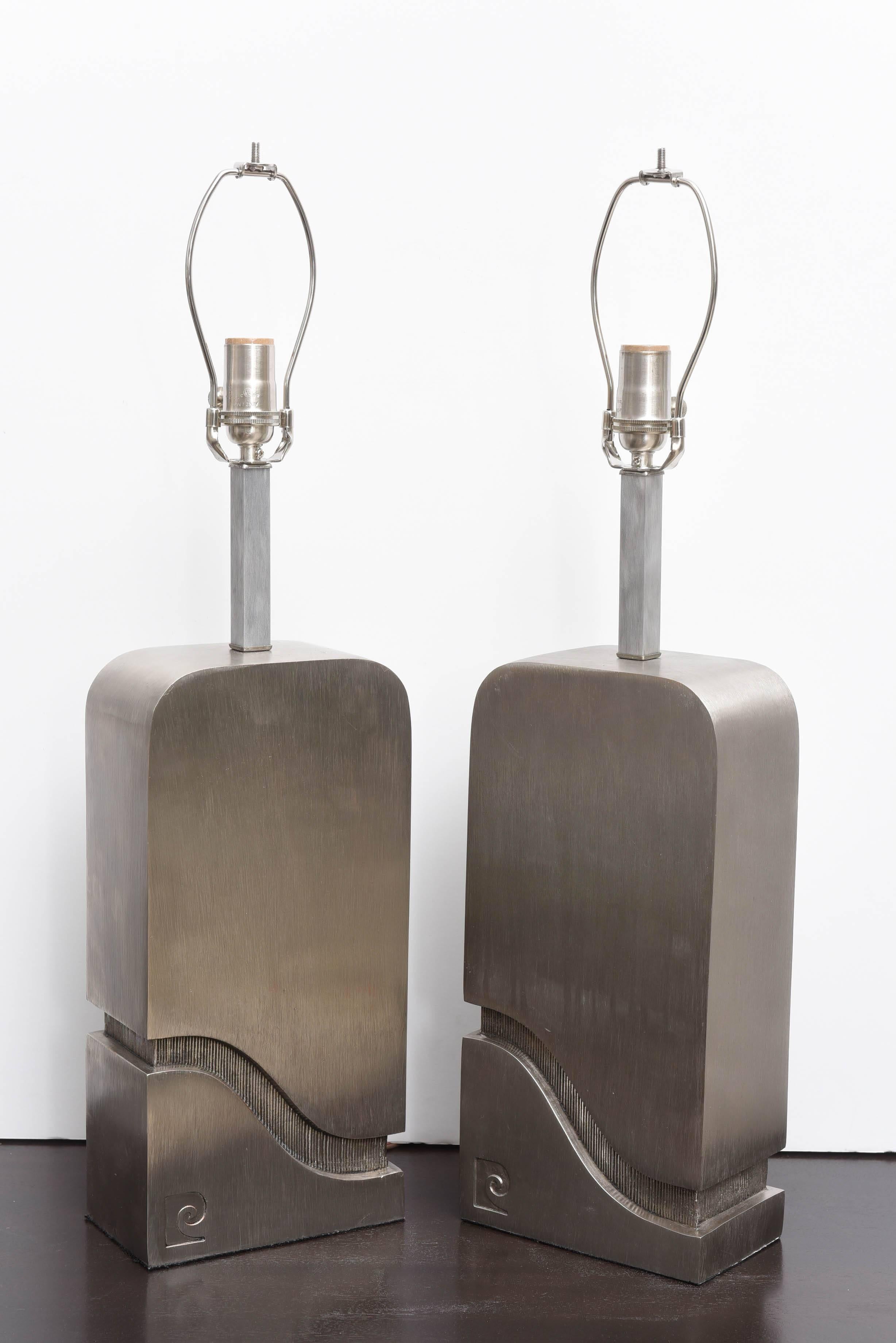 Pair of brushed steel Pierre Cardin table lamps.
The lamps bear the iconic logo located in lower left corners. The single socket accommodates traditional bulb.
 