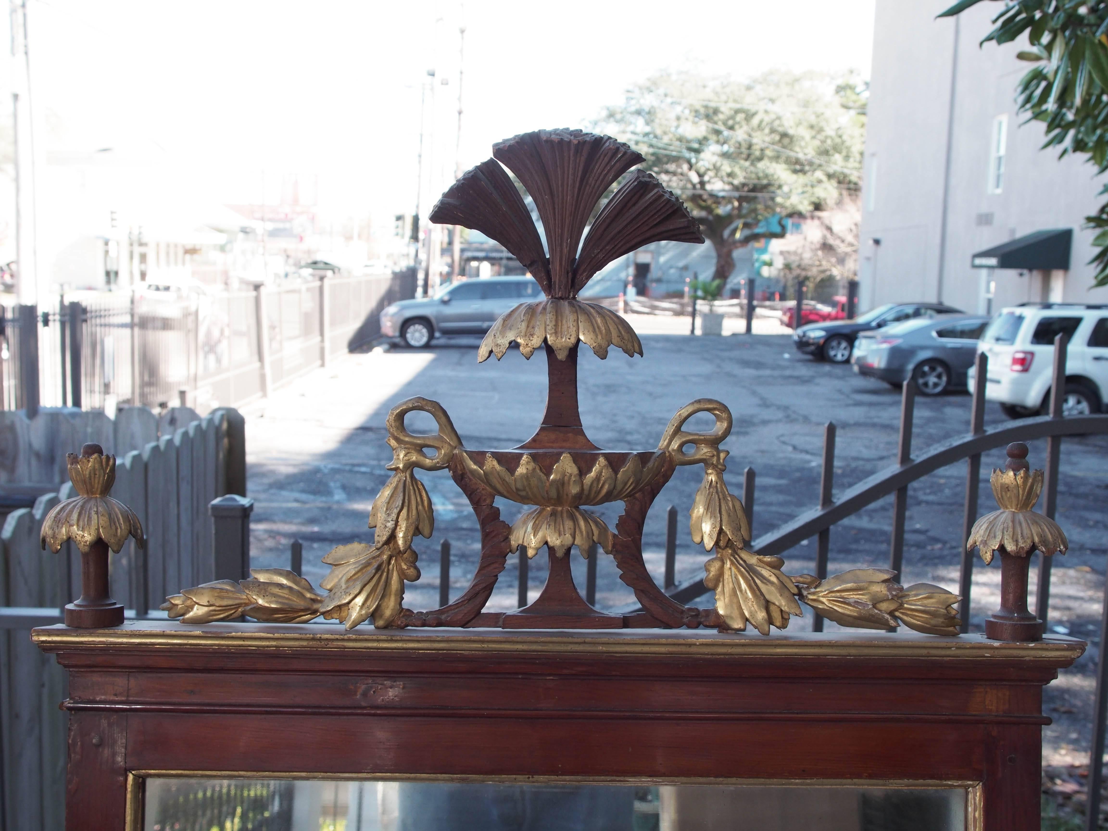 Pair of Italian faux bois and gilt neoclassical mirrors with plumed urn finials.