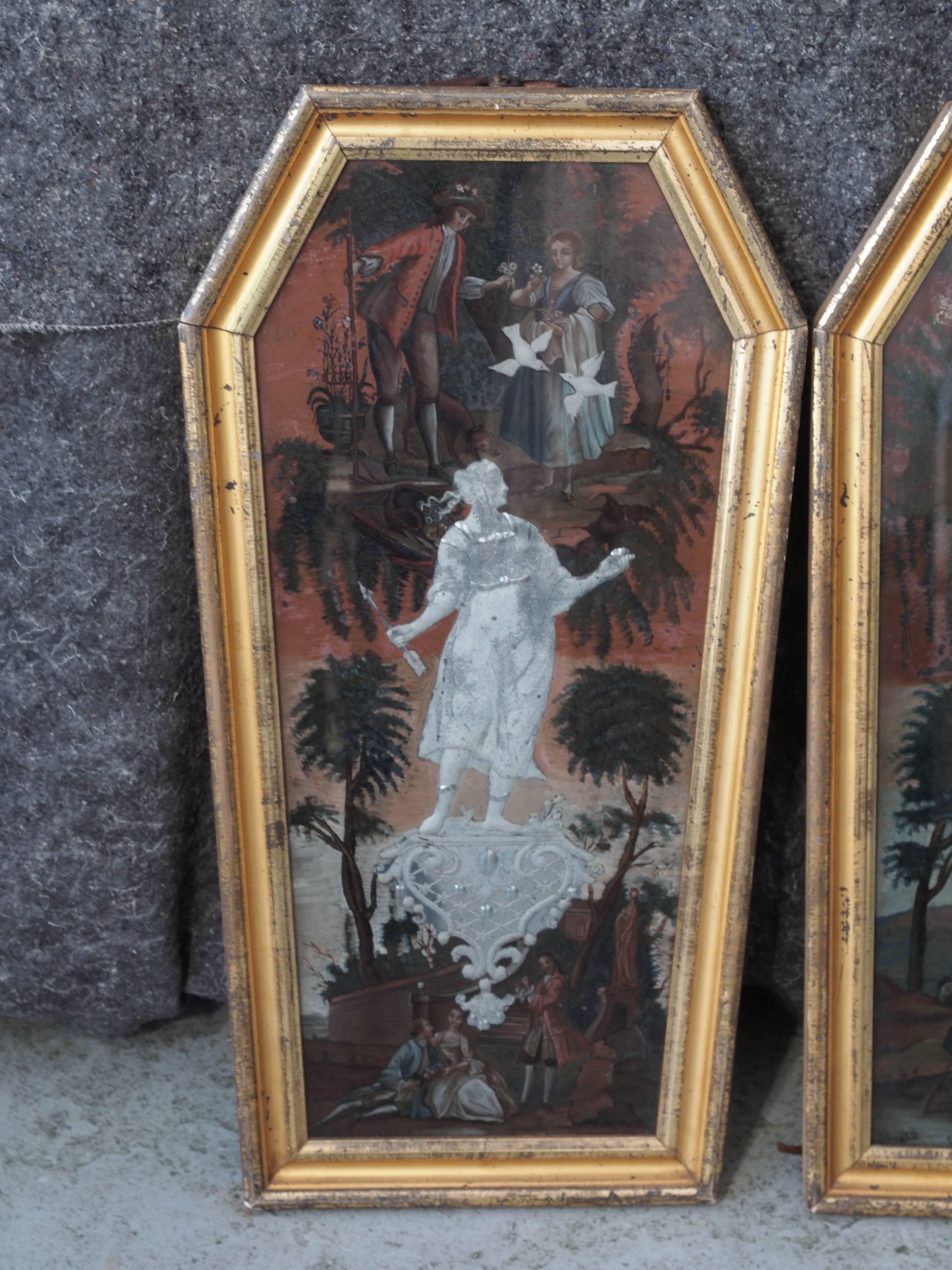 Pair of Venetian coffin shaped églomisé pained glass panels with cut figures that are mirrored.