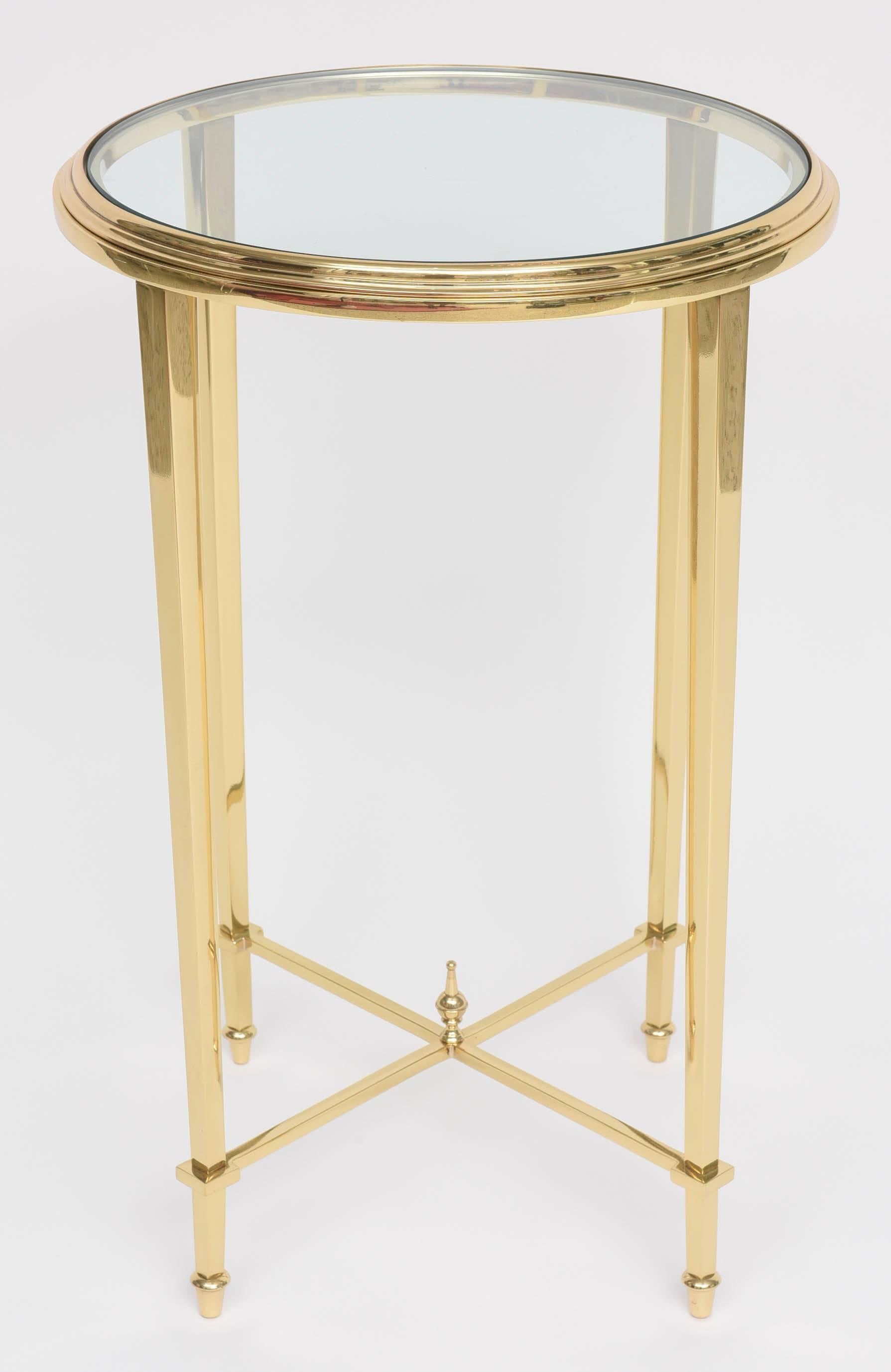 This stylish and chic brass and glass side table is very much in the style and quality of pieces created by the iconic firm of Maison Jansen in the 1960s. 

Note: This piece has been professionally polished and lacqurered and thus no tarnishing.

 
