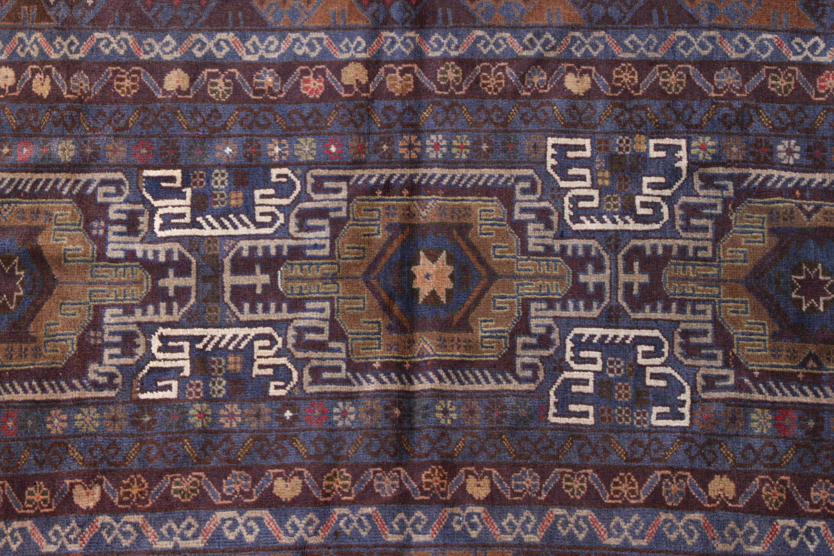 Antique Baluchi rug with three large geometric shapes running down the middle with white line details surrounding the. There are four rows of flower design running around the edge of the rug. Baluchi carpets are handmade carpets originally made by