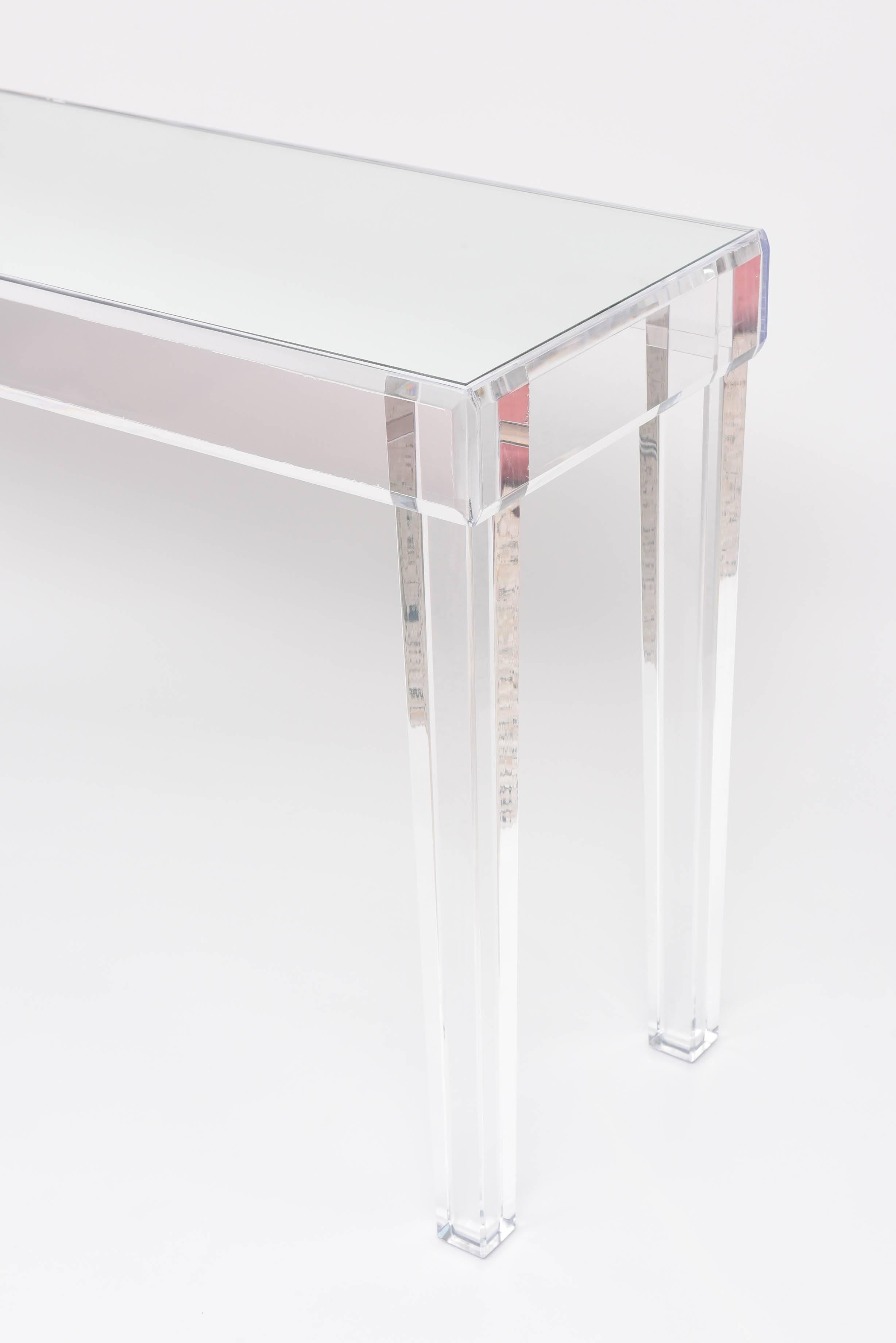 This beautiful lucite console is quite stylish with its Louis XVI style tapered legs and inset mirror top.  The piece is quite lite in appearance and make for the perfect entry hall piece, dining room buffet or bar.

Please feel free to contact us