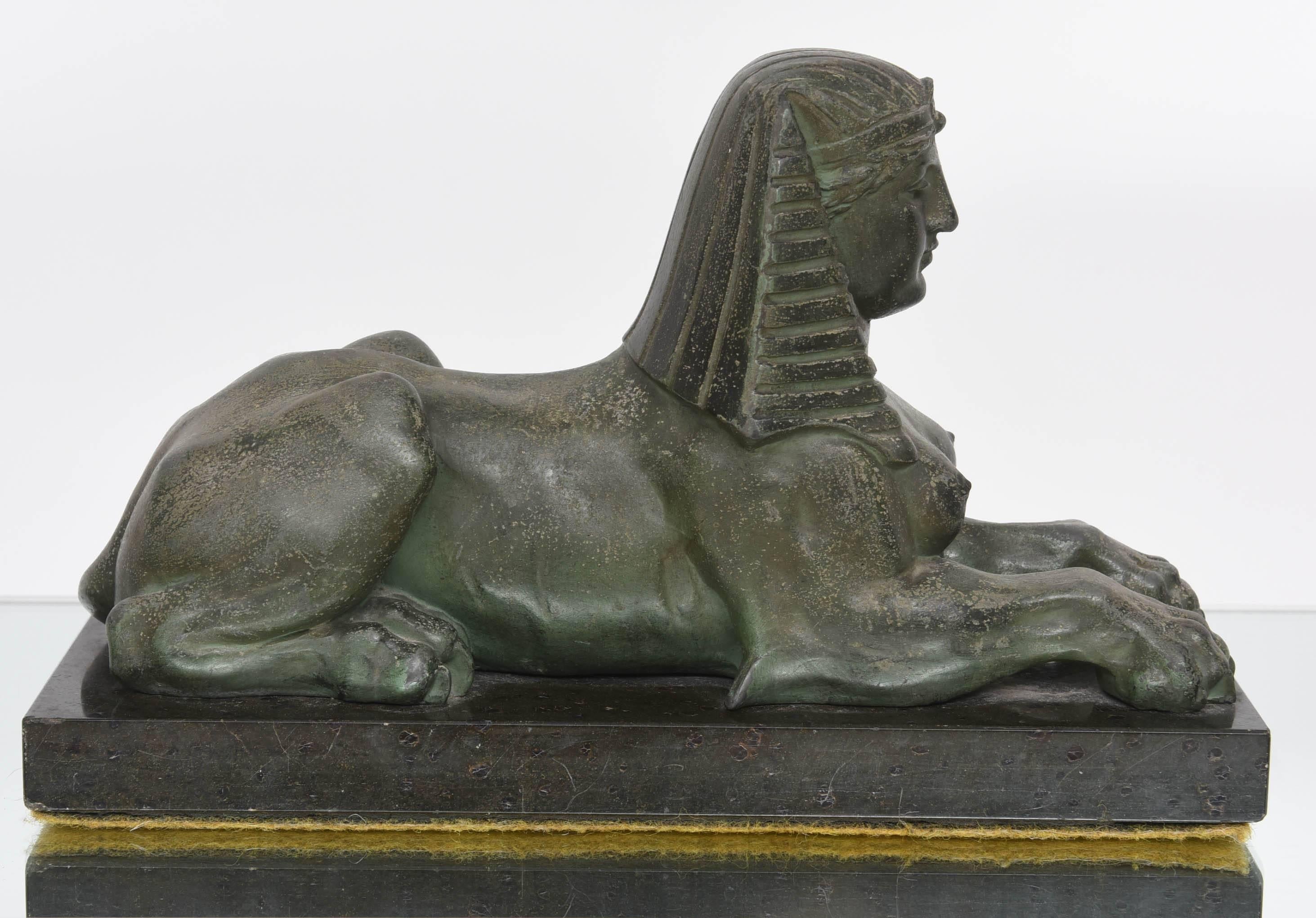 This handsome piece was created in the late 19th to early 20th century.  It is cast in a base metal which has a faux bronze finish and sits upon a black marble  base.

Note:  There is a small chip on the back corner of the piece (see