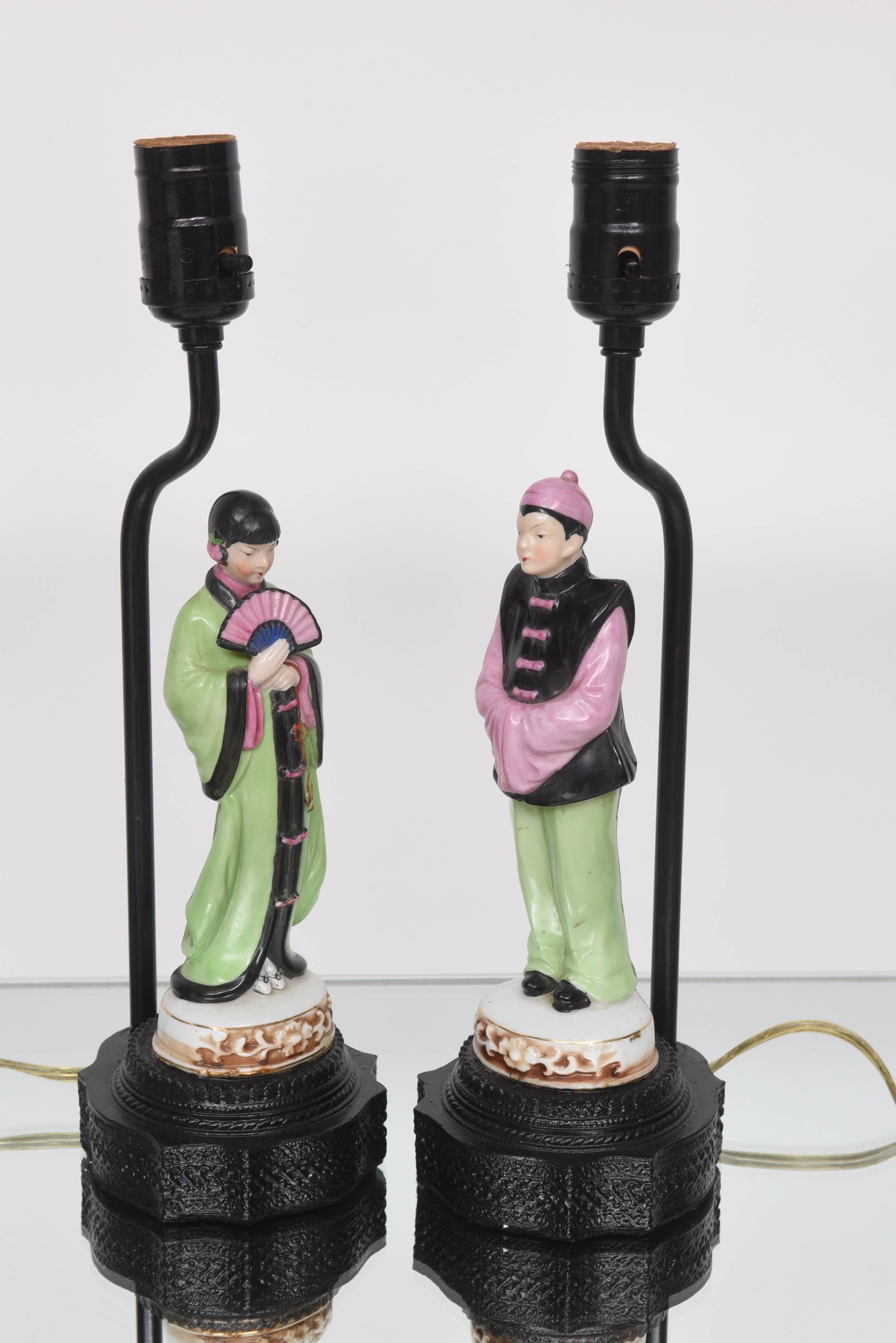 This beautiful pair of vanity lamps evoke the exotic orient of the Art Deco period and will make the perfect addition to your home. The figures are in popular colors of that period with the black, lime-green and pink and sparkle with the light.
