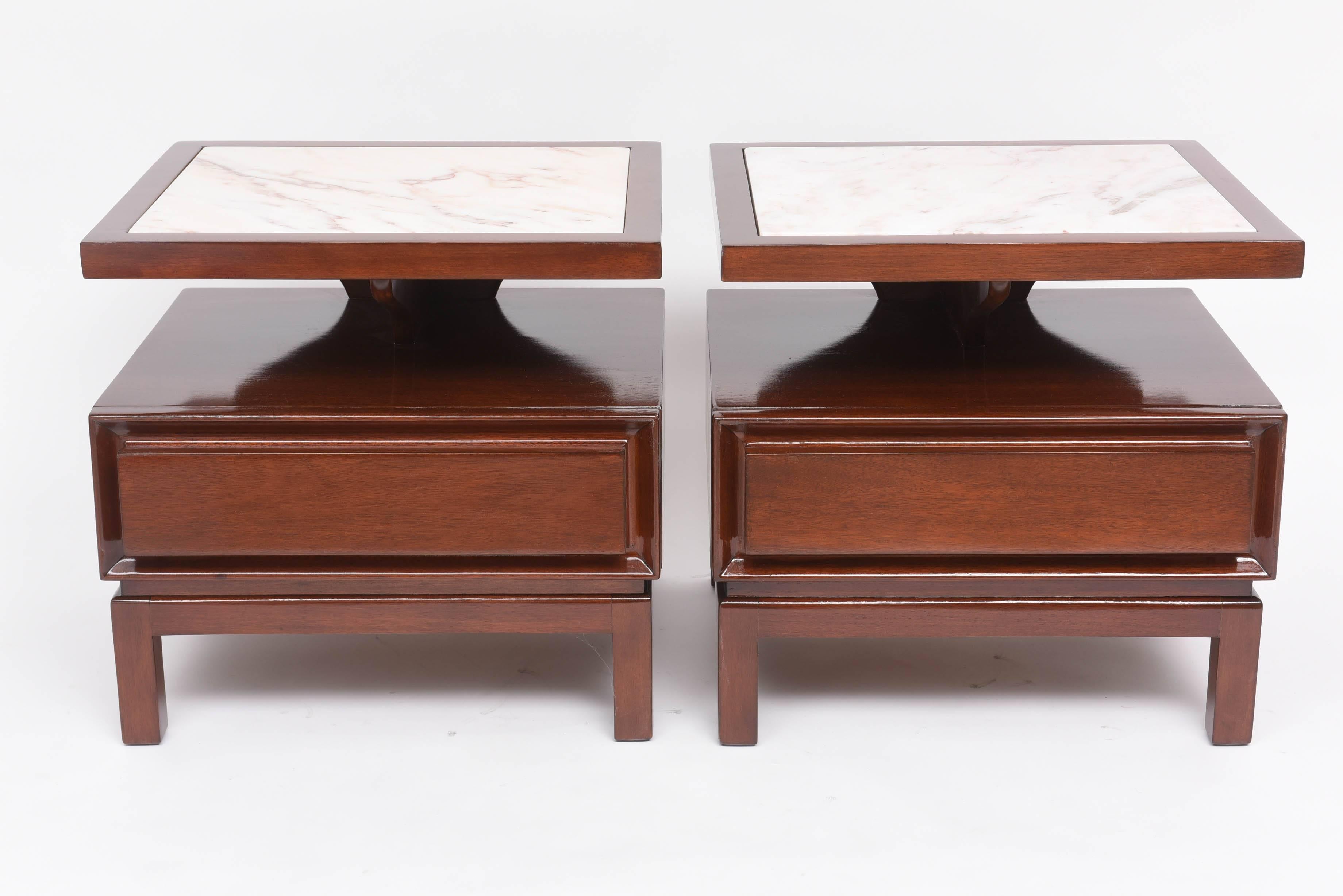 This handsome pair of mahogany and marble tables were created in the 1940s and are in the style of pieces designed by Harvey Probber.  The pieces have an American Modern sense to them with their asian overtones combined with the cantilevered