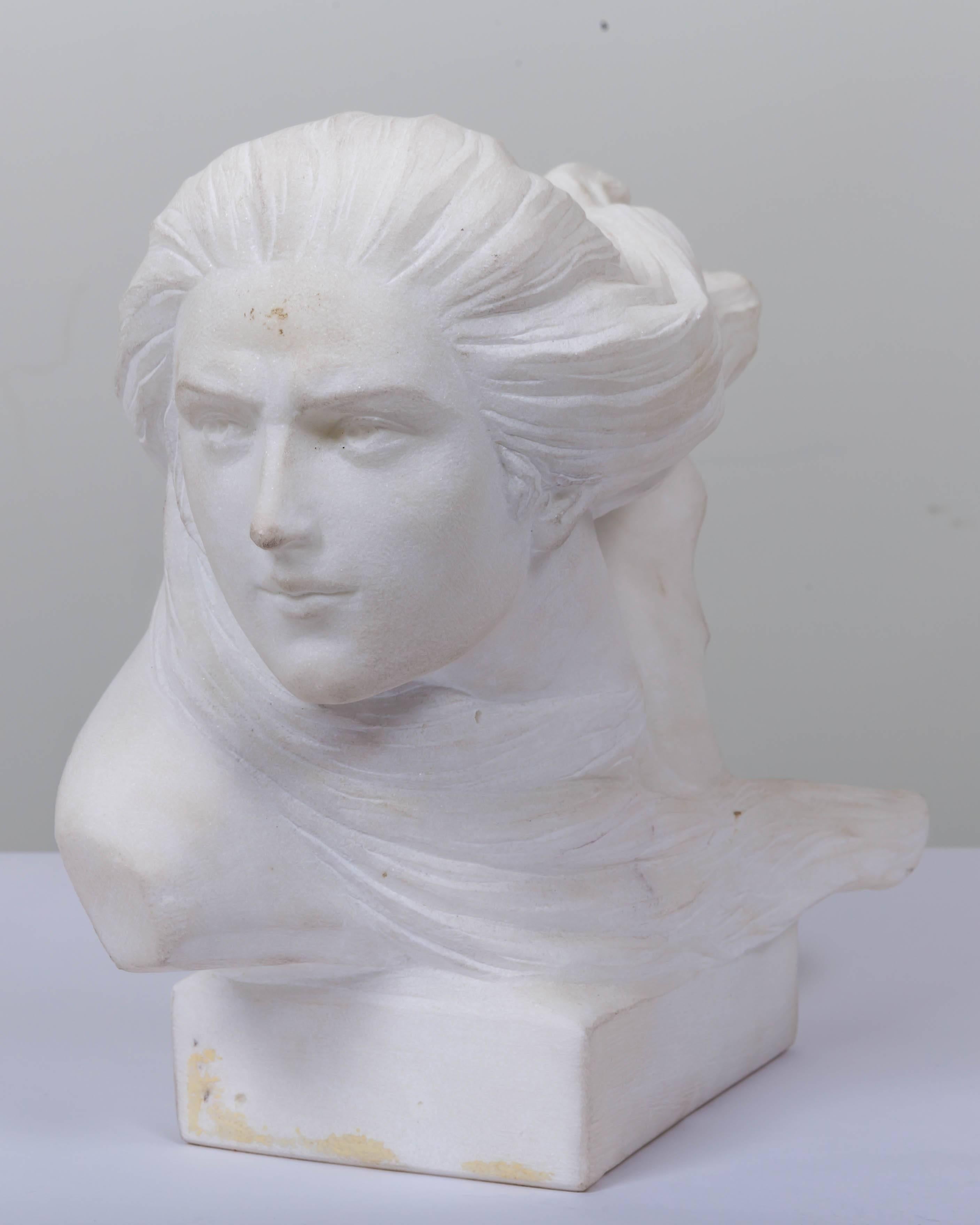 Alabaster bust of woman with flowing hair in the style of Art Noveau.