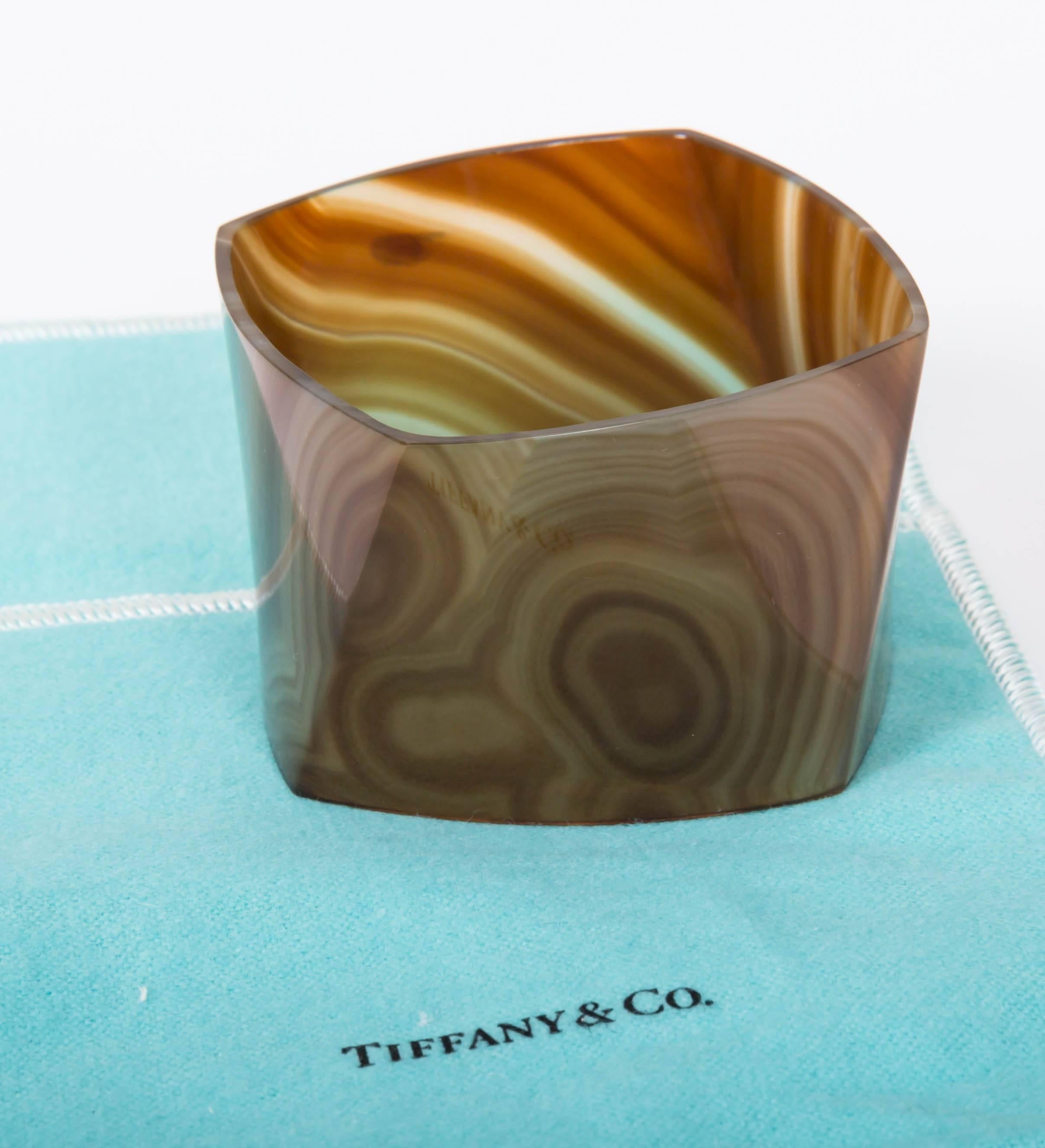 Highly figural banded agate carved from one-piece of stone to form torque bracelet.