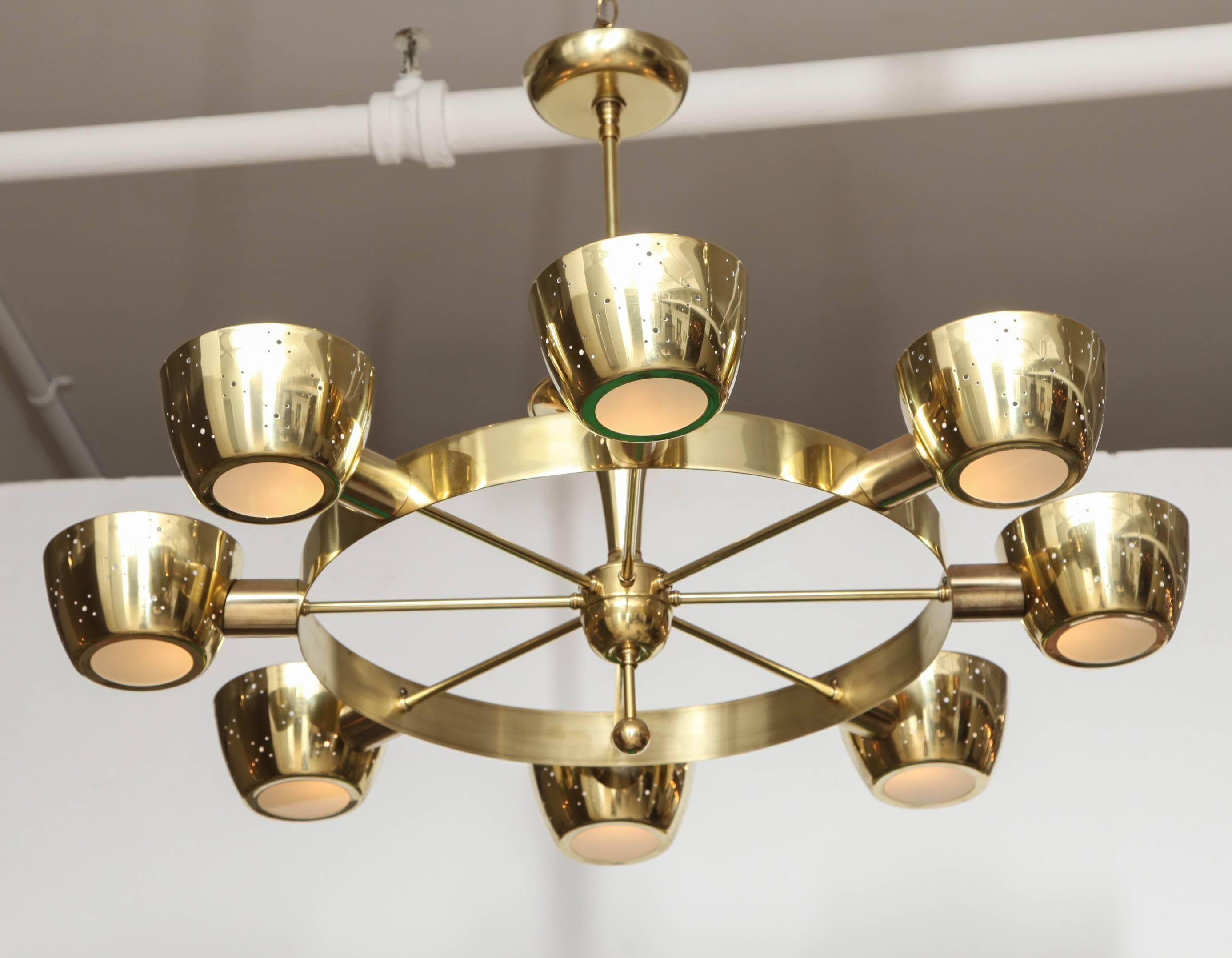 Eight-light cups in pierced brass with frosted glass bottom inserts provide filtered edge lighting, uplighting and down lighting. Newly repolished and rewired, otherwise original throughout. Designed by Gerald Thurston for Lightolier, late 1950s.