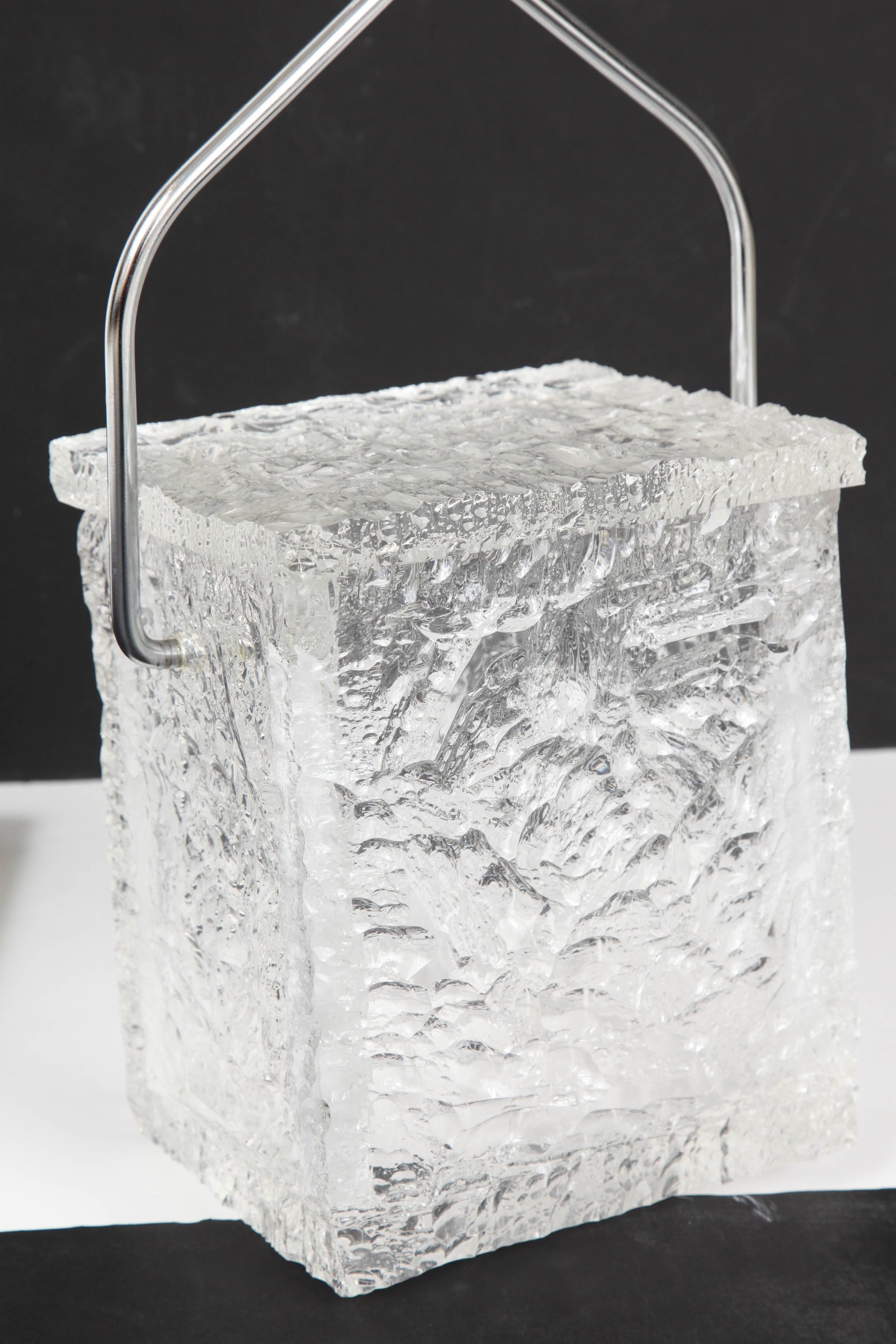 Textured massive Lucite hinged-lidded box replicates a solid block of ice, the chrome handle in the form of ice tongs. American, 1960s. Excellent original condition throughout. Bucket 9" high with handle folded.
