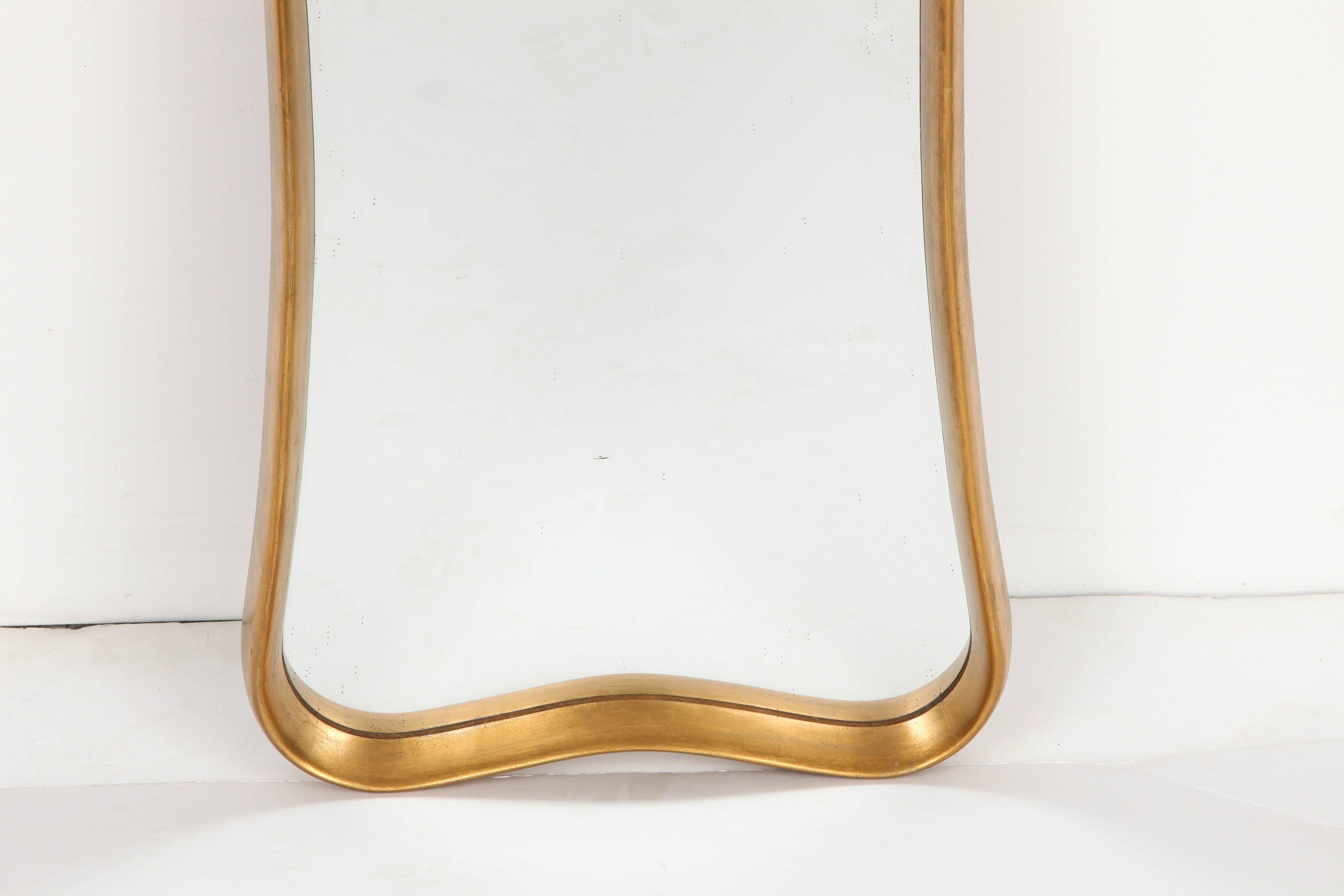 Shaped giltwood frame surrounds a conforming mirror plate, Italian, dated 1963 on reverse. Very good original condition, minor wear and losses to gilding.