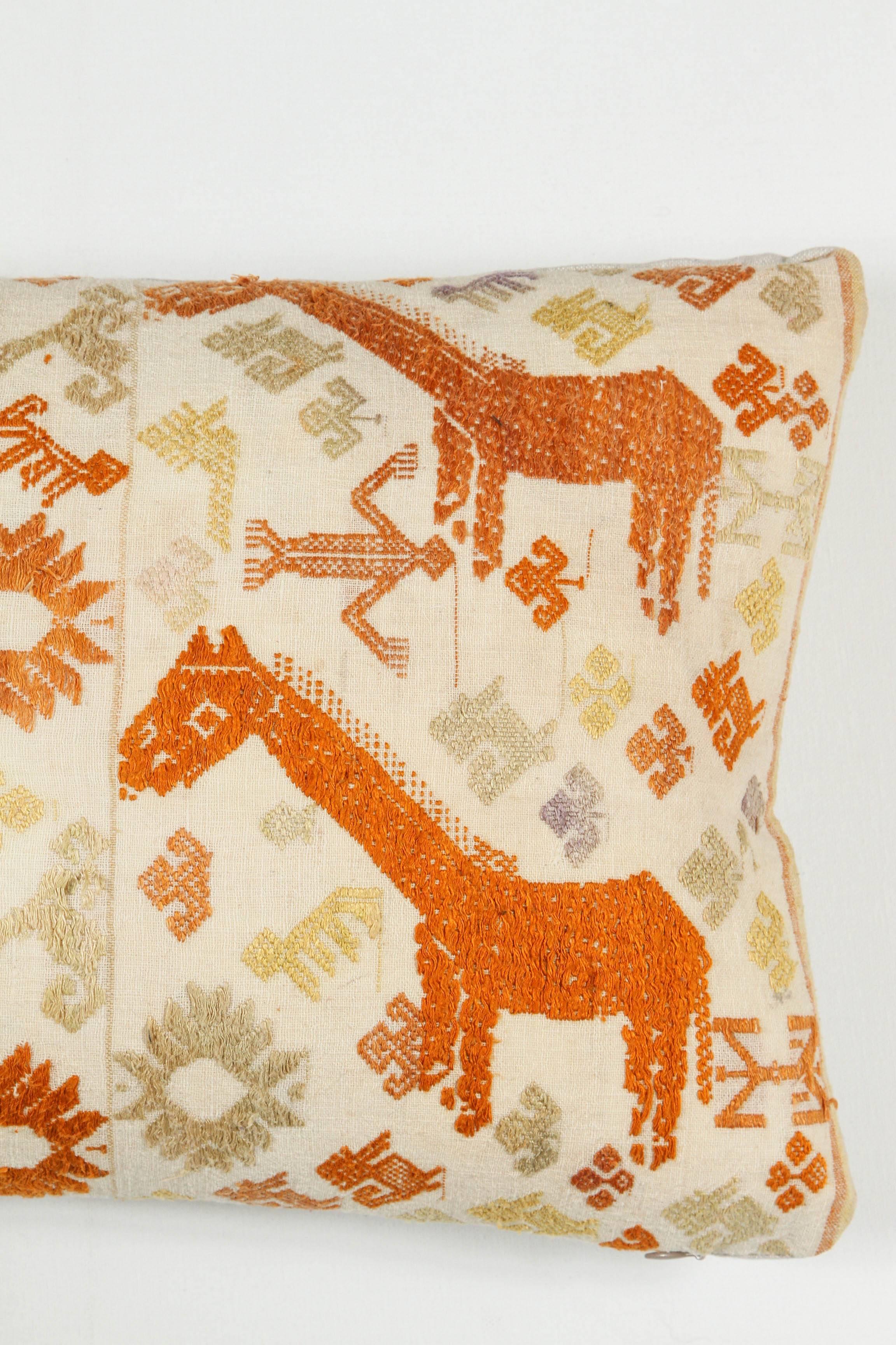 Vintage Tai (Ethnic minority group resident in Laos and Vietnam) Hill Tribe textile pillow.  Hand embroidery.  Cotton floss on handwoven cotton fabric.  Dragon and giraffe motif.  Natural linen back,  invisible zipper and feather and down fill.  