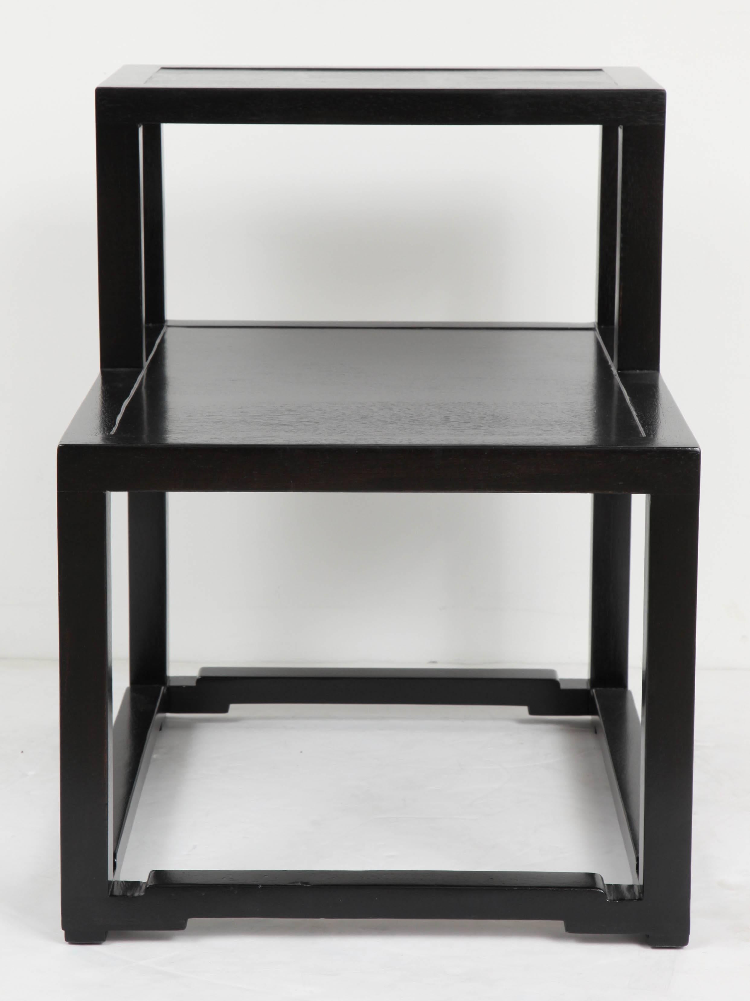 Pair of ebonized mahogany end tables with stepped top and Asian inset detail by Edward Worley for Dunbar.  Signed with stamped mark.  USA, circa 1950.

Dimensions (inches):
Overall 24