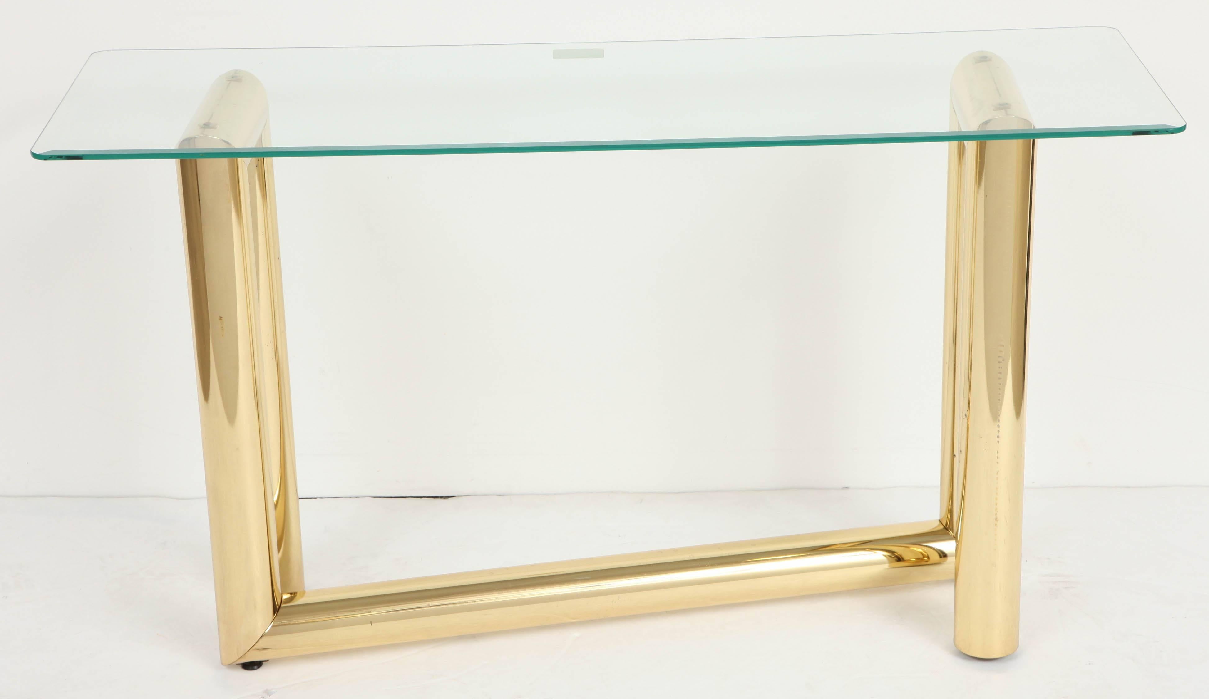 A Z-shaped brass and glass console table. USA, circa 1970.  Polished brass base supports a removable beveled edge glass top.  Item may be viewed at the 1stdibs 200 Lexington showroom.

Dimensions (inches):
Overall 48