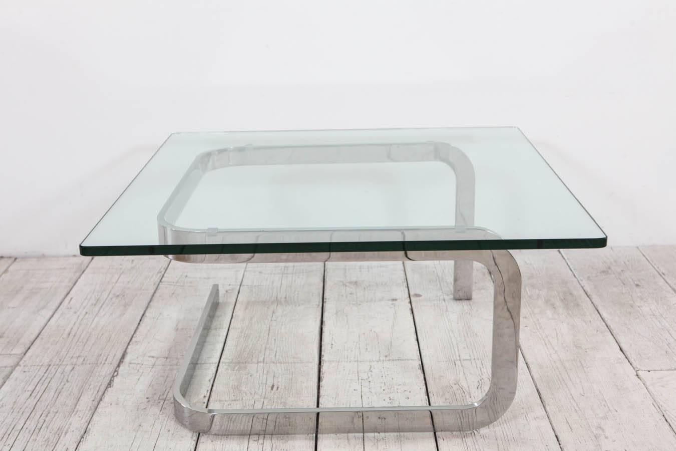 Bent metal base cocktail table with thick glass top. Designed by Steven Becker.