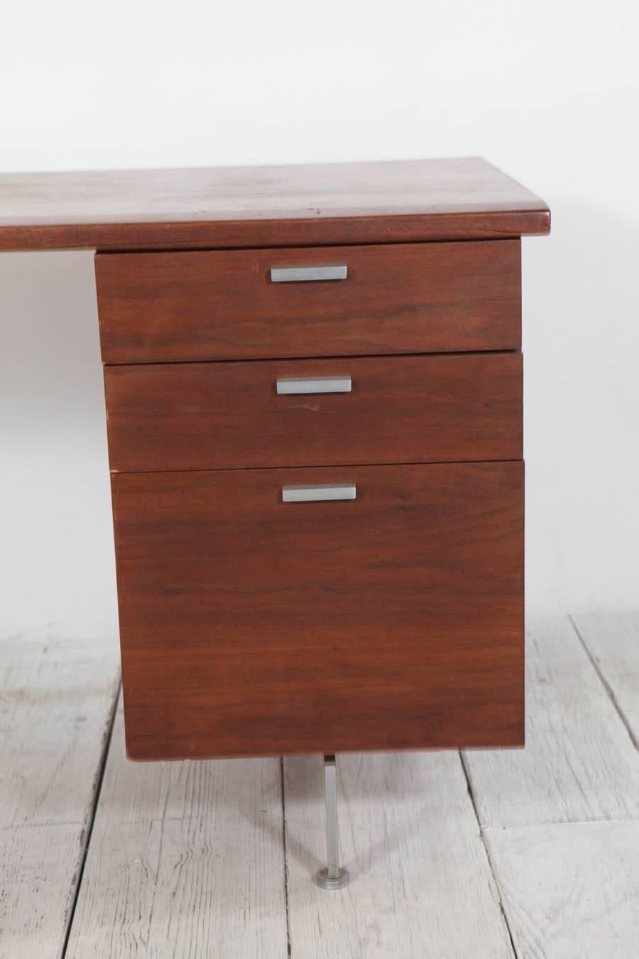 Classic mid-century modern secretary's desk with two stationery drawers and one filing cabinet drawer.