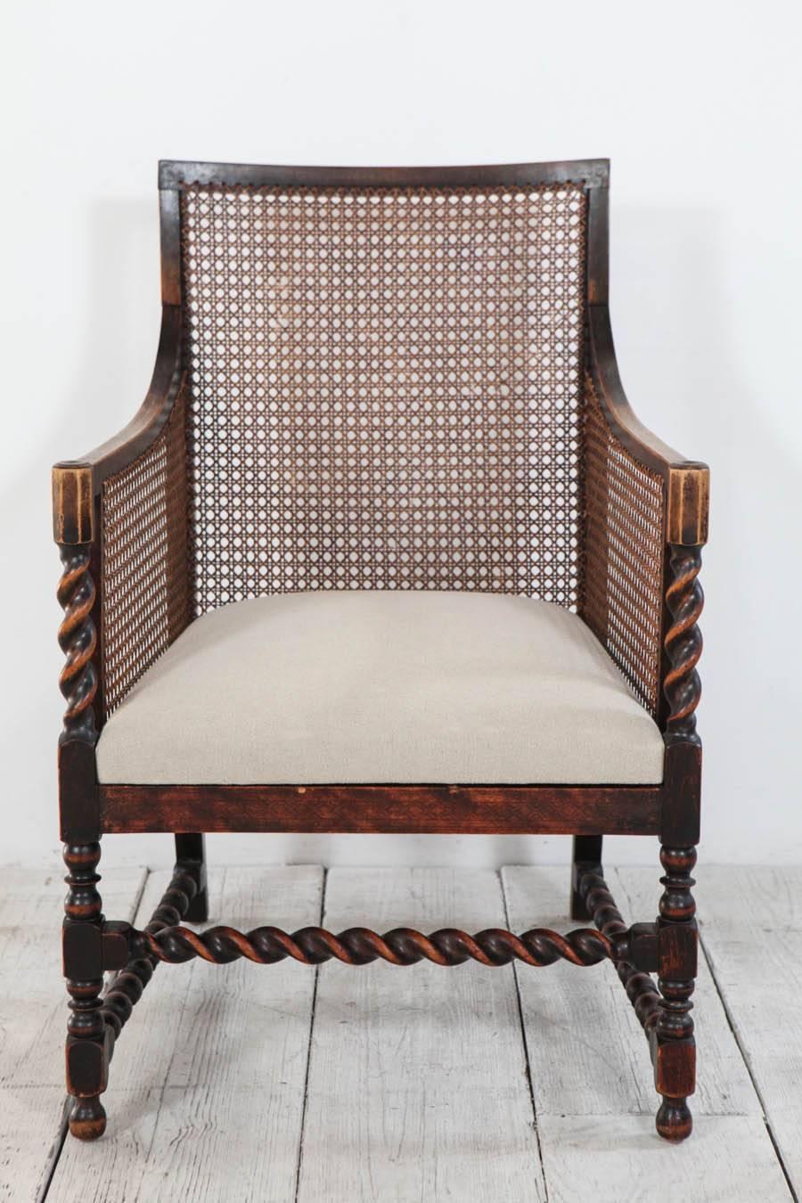 Beautiful one-of-a-kind armchair with exceptional cane and turned wood details.