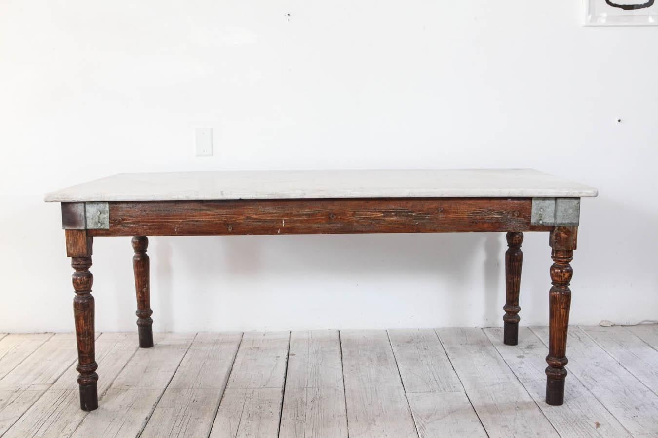 Vintage farm / work table with zinc metal details on corners and white likely Carrara marble top with beautiful patina.