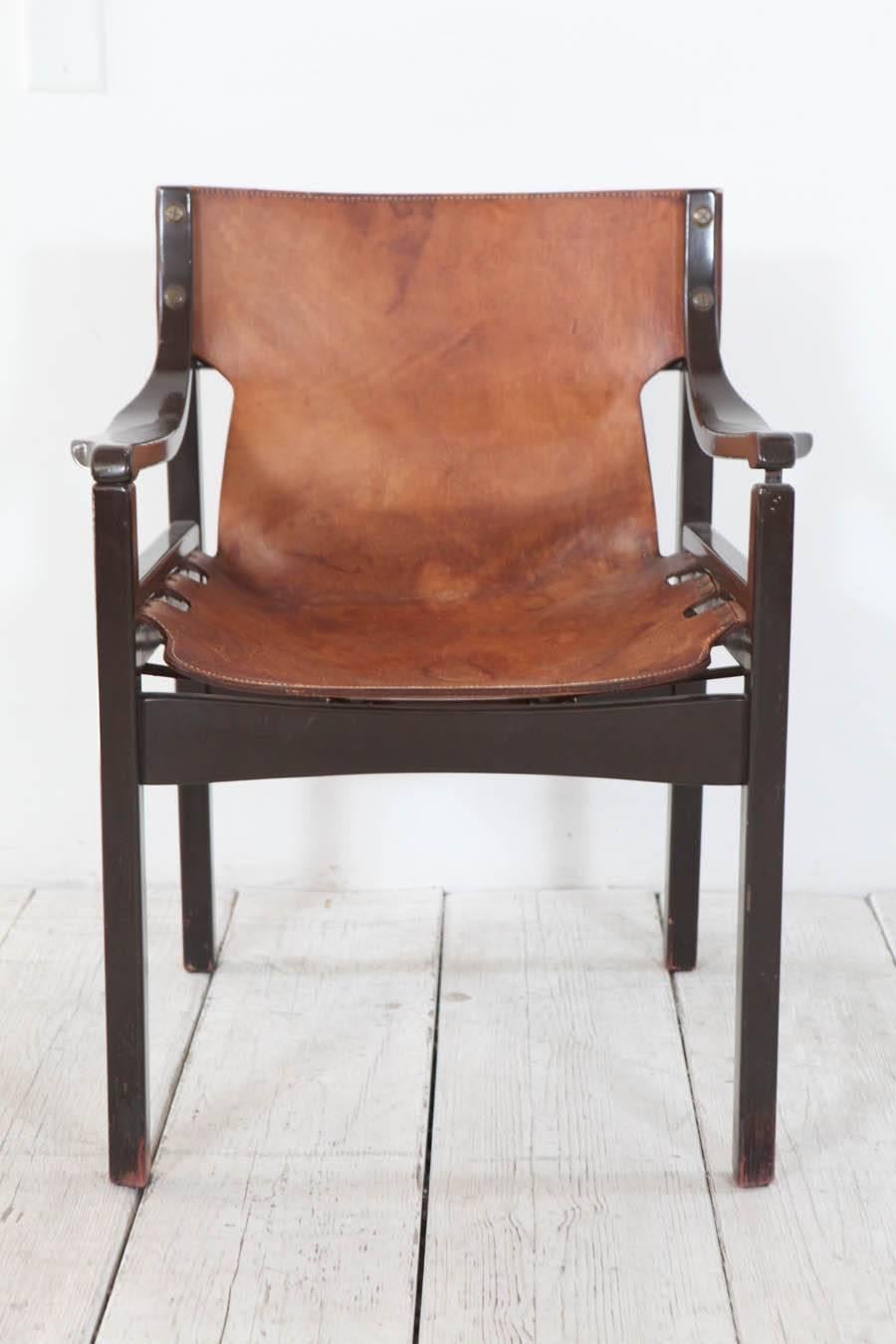 Chocolate brown enameled bentwood armchair with thick leather sling seat.