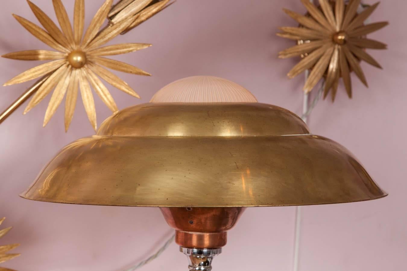 Elegantly shaped Italian table lamp in brass, copper, chrome and glass. Three tiered domed shade of brass and glass sits on a curved stem, supported by brass and chrome base.