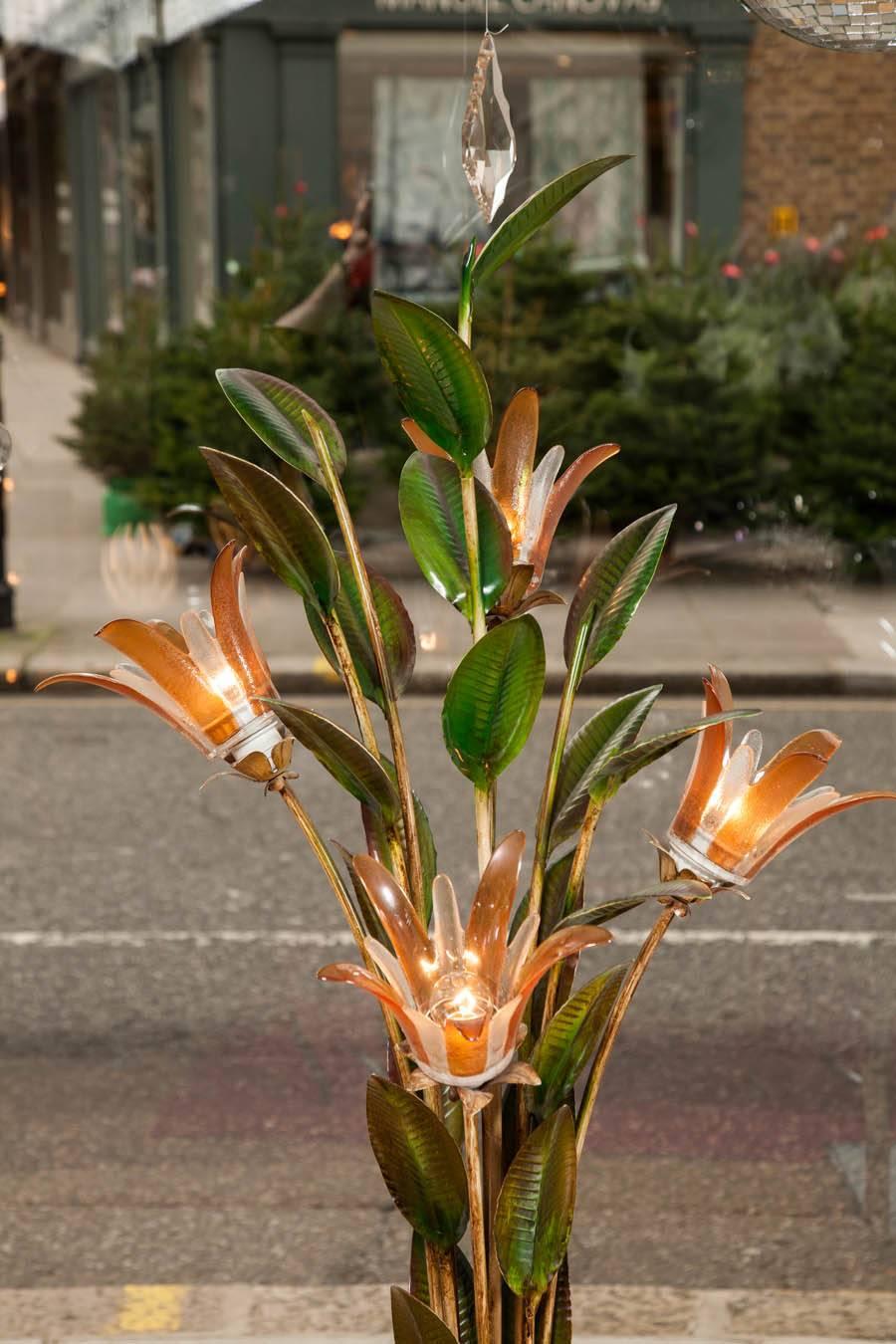 Unusual Standard Lamp of painted metal stalks with leaves supporting four hand-blown glass flowers in delicate shades of umber, standing on a twisting circular base.