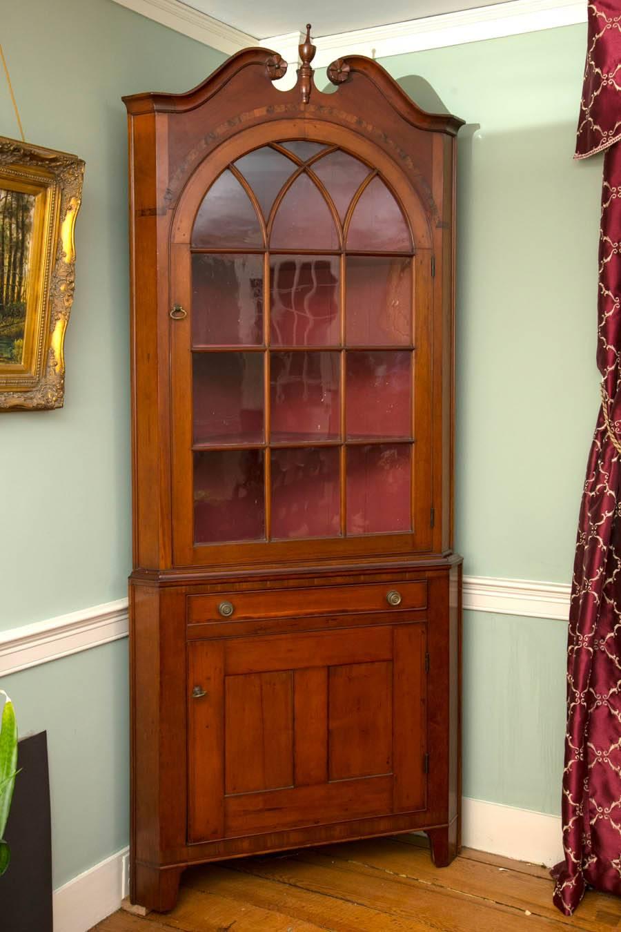 Rare Montgomery county, Pennsylvania Hepplewhite two-piece broken-arch cherry corner cupboard with carved rosettes, arcaded door, spoon rack, with drawer at the waist. Spectacular inlaid burl over the arched door. Excellent proportions,

circa