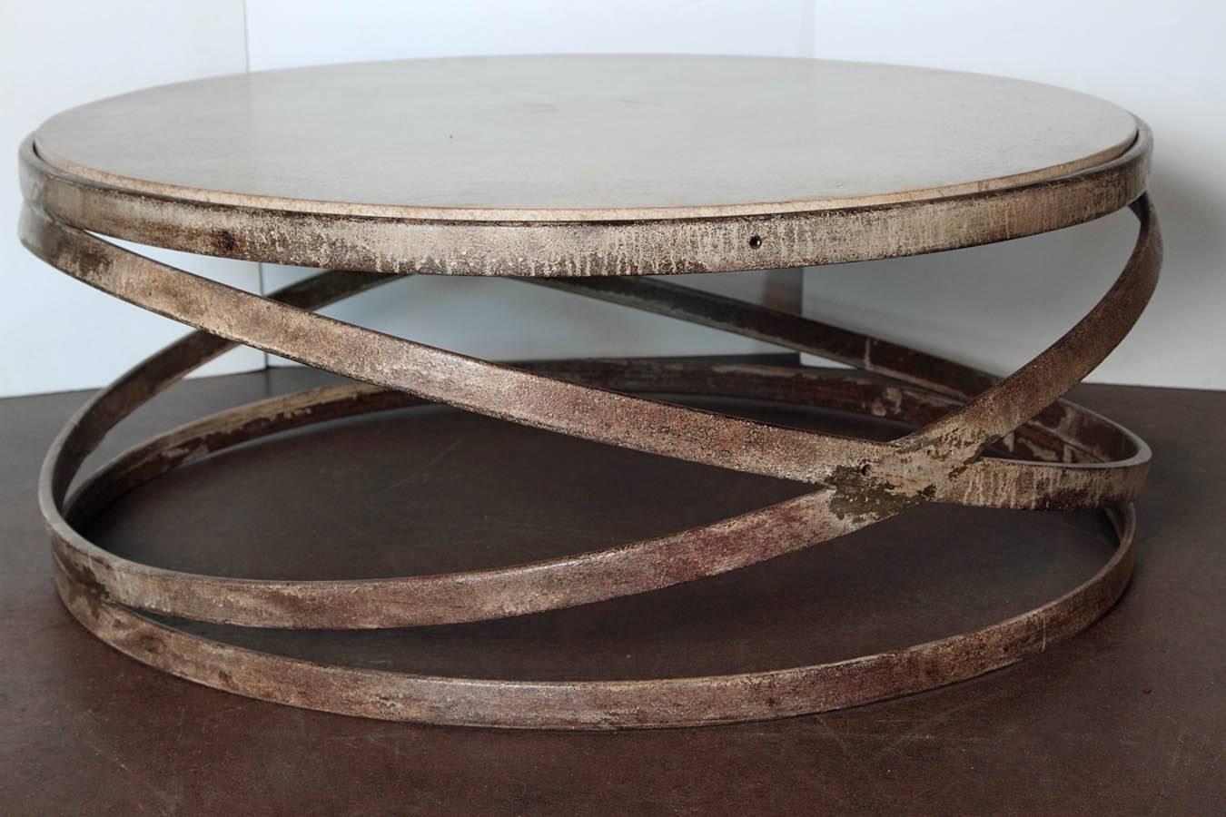 Reclaimed Modern style ring coffee table.

Industrial rings from Marseilles, France.
 
Architectural tubular weave of the netting of rings with distressed piece of limestone, as a top completes the design.

  