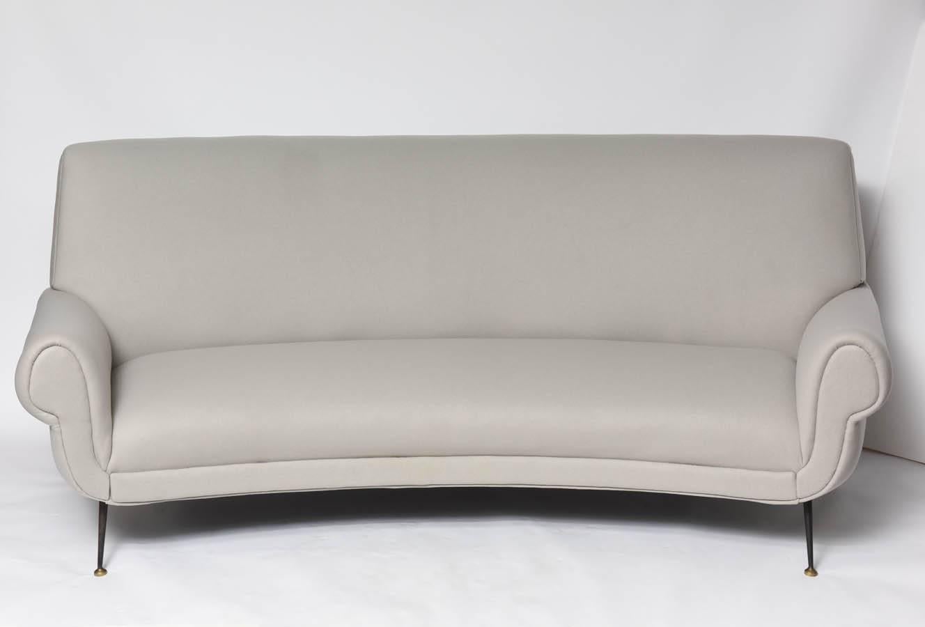 Newly upholstered in fine felt light grey wool upholstery, Italy, 1950s.

Beautiful vintage Gigi Radice sofa with original lacquered metal and brass legs showing normal wear and patina.

This item is currently in our Miami showroom. Please call