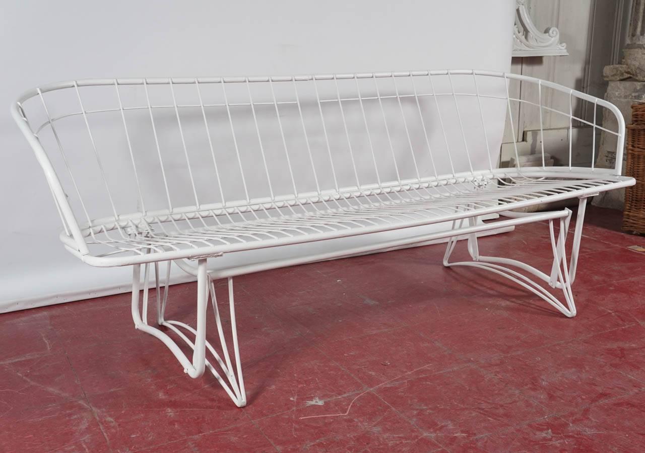Painted white, these vintage wrought iron porch pieces are made to hold cushions of your choice. Wonderful for the deck or patio.

Arm height for chairs: 27.50.
Gilder: 72