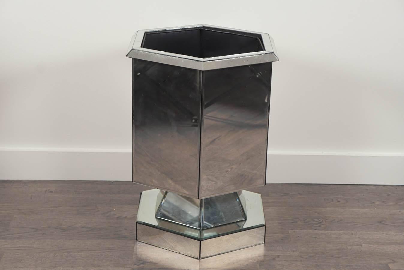 Six sided, hexagon footed planter, in handsome mitered and beveled mirror.
With black metal removable liner. Several chips in the mirror, consistent with age and use.