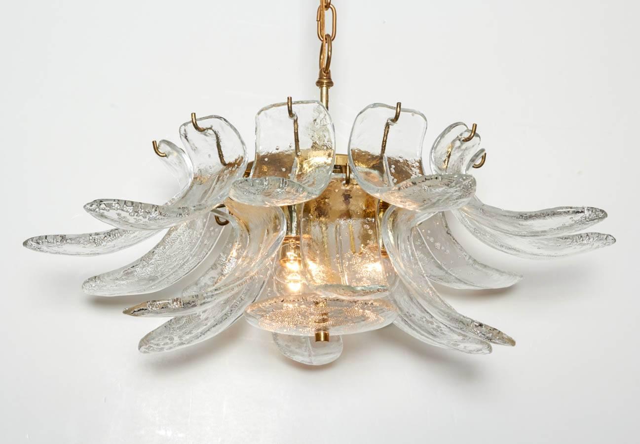 Wonderful, striking chandelier with thick, sculpted Mazzega art glass crystals. Each crystal was blown with controlled bubbles which add texture and sparkle. Chandelier has a brass armature. Please contact for location. 