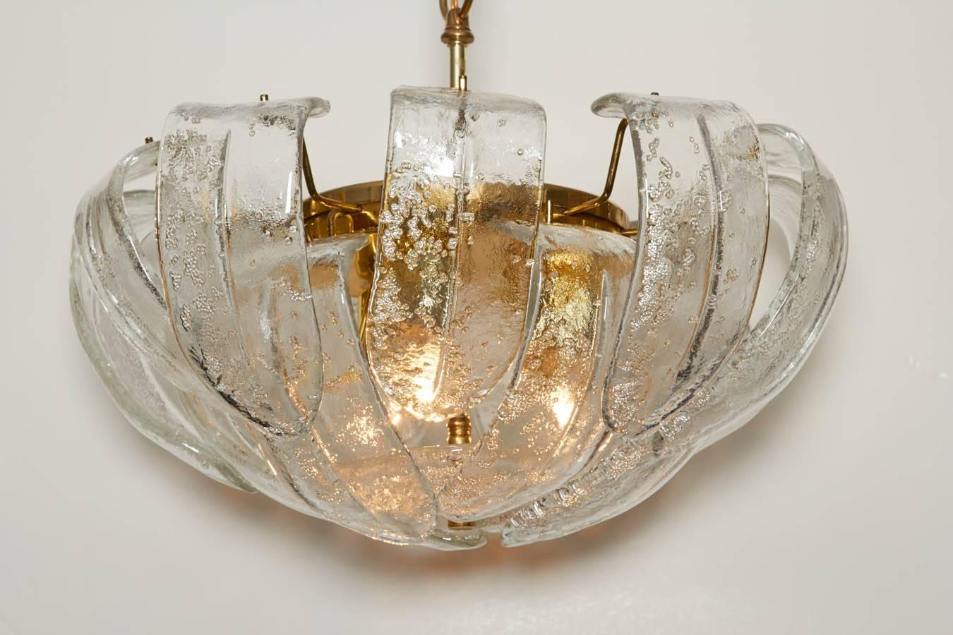 Lovely chandelier with thick, sculpted Mazzega art glass crystals. Each crystal was blown with controlled bubbles which add texture and sparkle. Chandelier has a brass armature. Please contact for location.