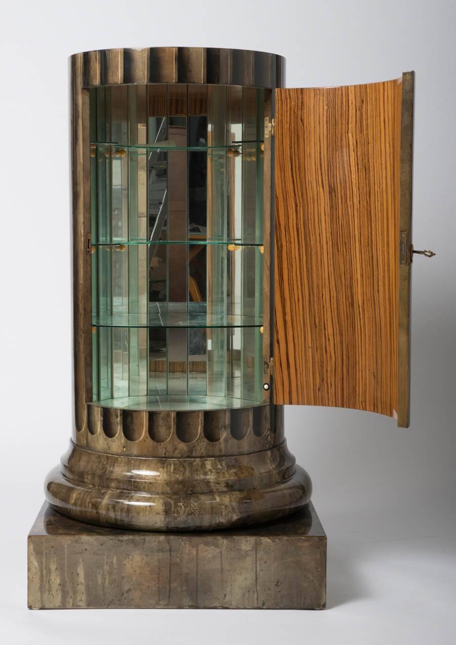 A rare and exceptional drinks cabinet by Aldo Tura.
Modelled as a Roman column.
Coloured goatskin and lacquered.
The interior lined with original glass,
Italy, circa 1950.
Measures: 130 cm H x 68 cm diameter.
 