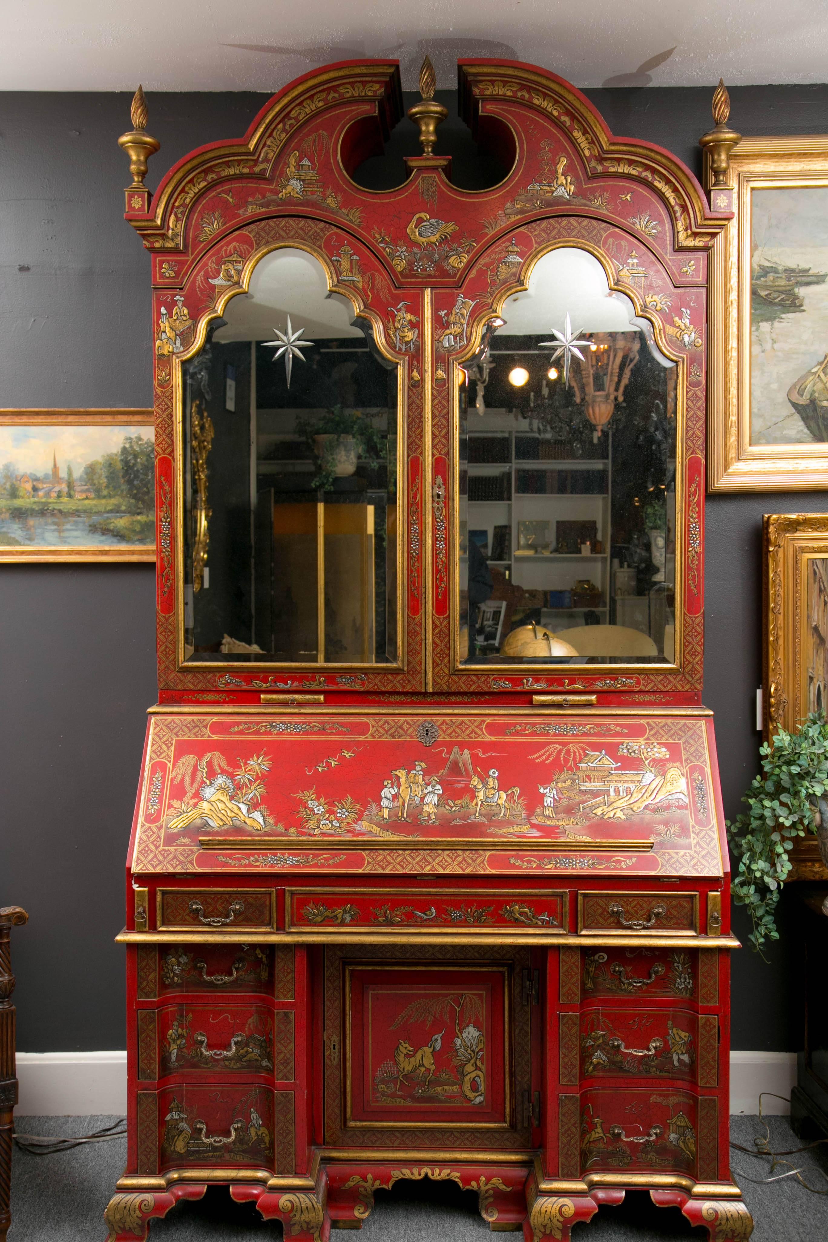 Exceptional hand-painted English red chinoiserie secretary with mirrored doors and multiple hidden compartments.