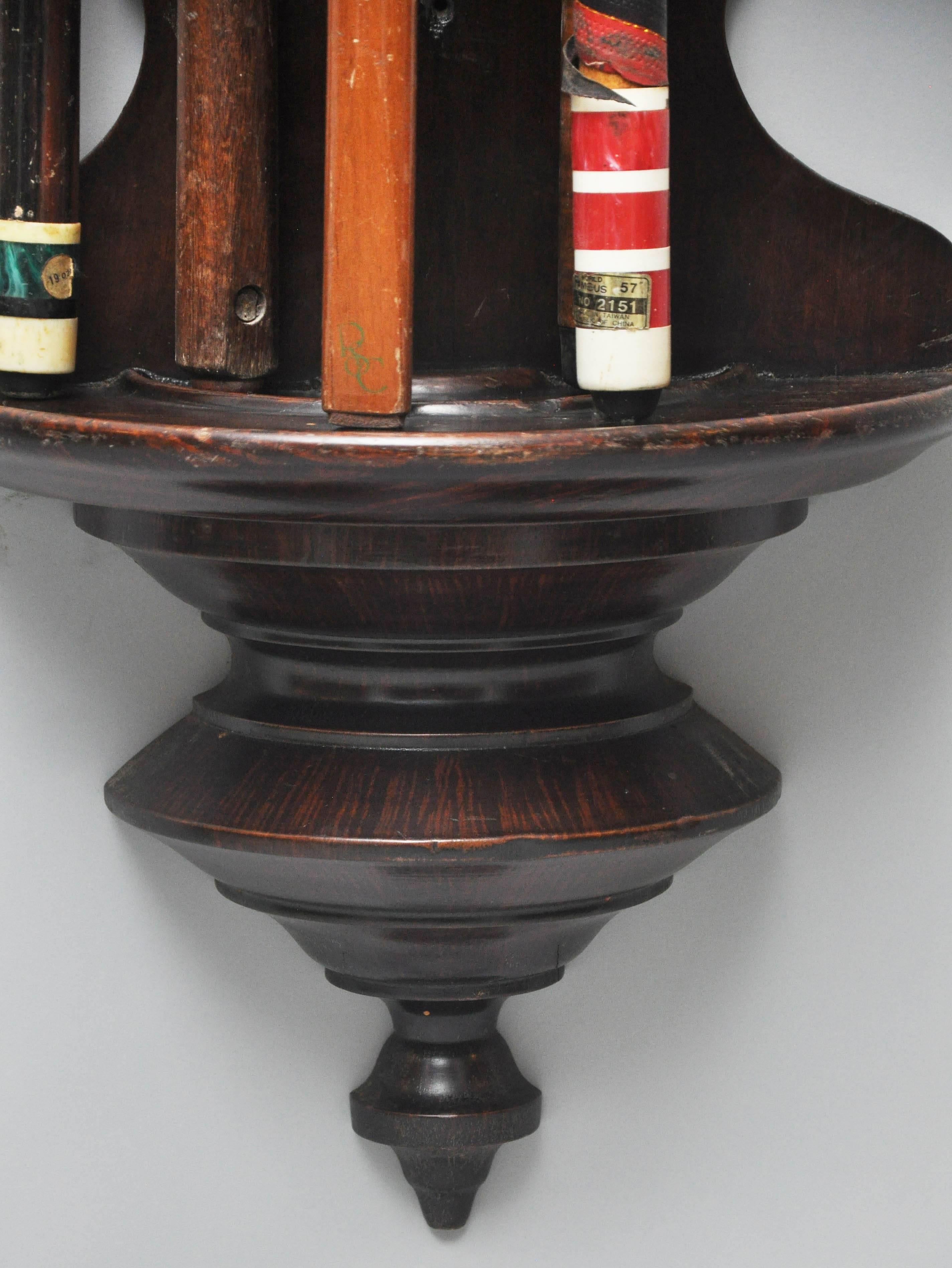 19th century flamed mahogany snooker / billiards wall cue rack, supported on a turned pedestal, holds up to 14 cues.