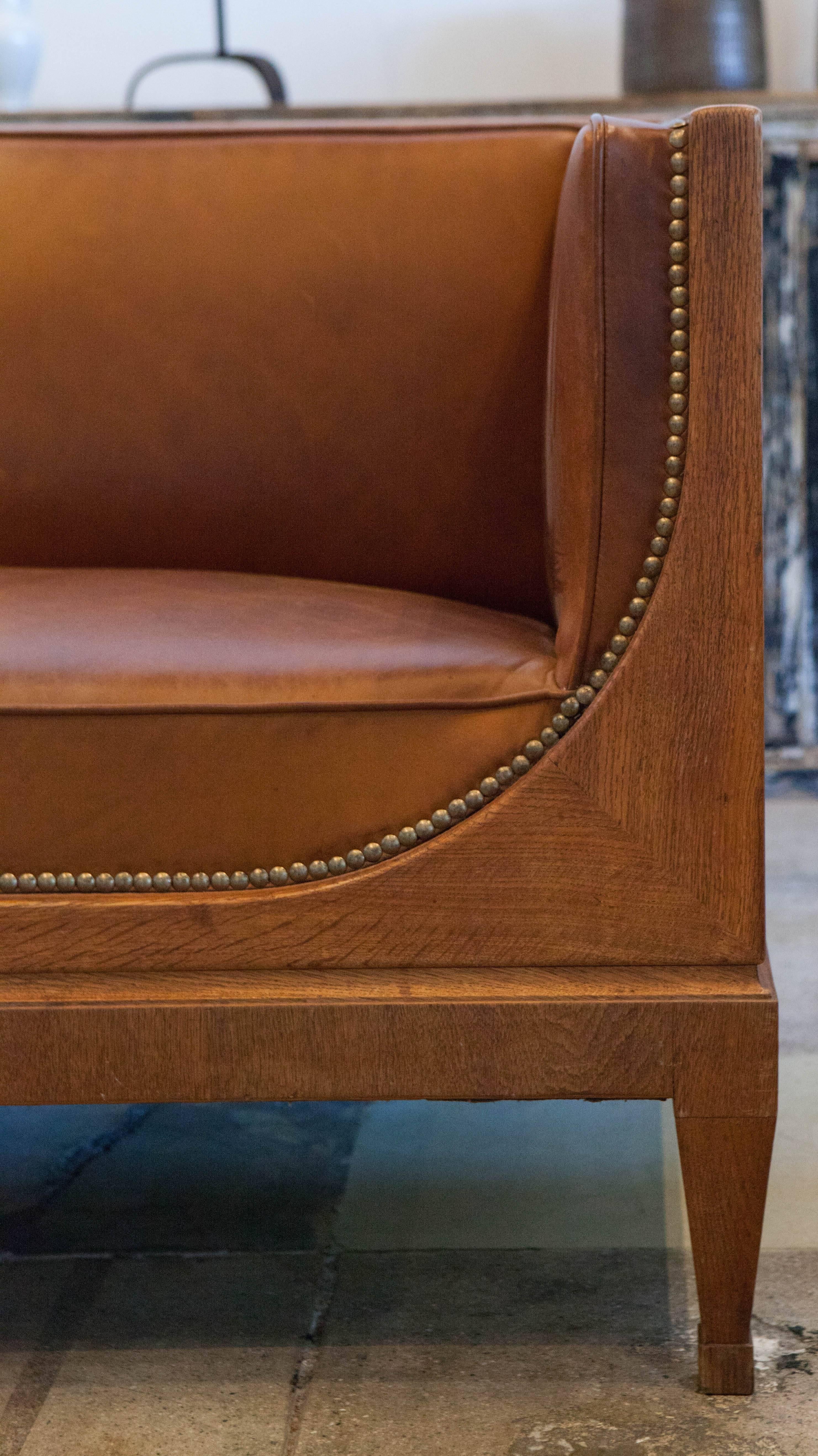 A beautiful example of Frits Henningsen's mahogany framed three-seat.