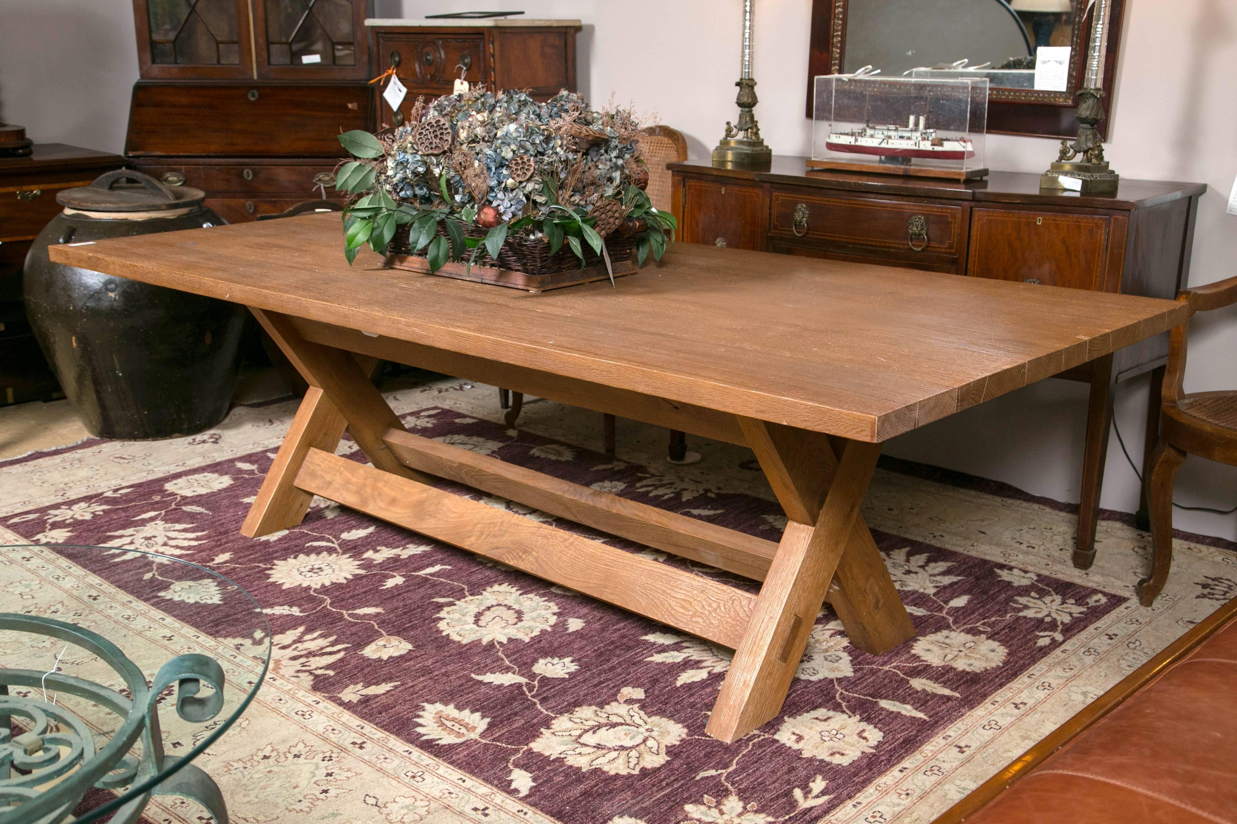 Desert modern dining table by Ralph Lauren. Hand fitted mortise and tenon Joints. Fabulous mix of modern and traditional. A rustic hewned wood X-form farm table. A soft natural organic modern/traditional aesthetic. Seats eight-ten comfortably. Great
