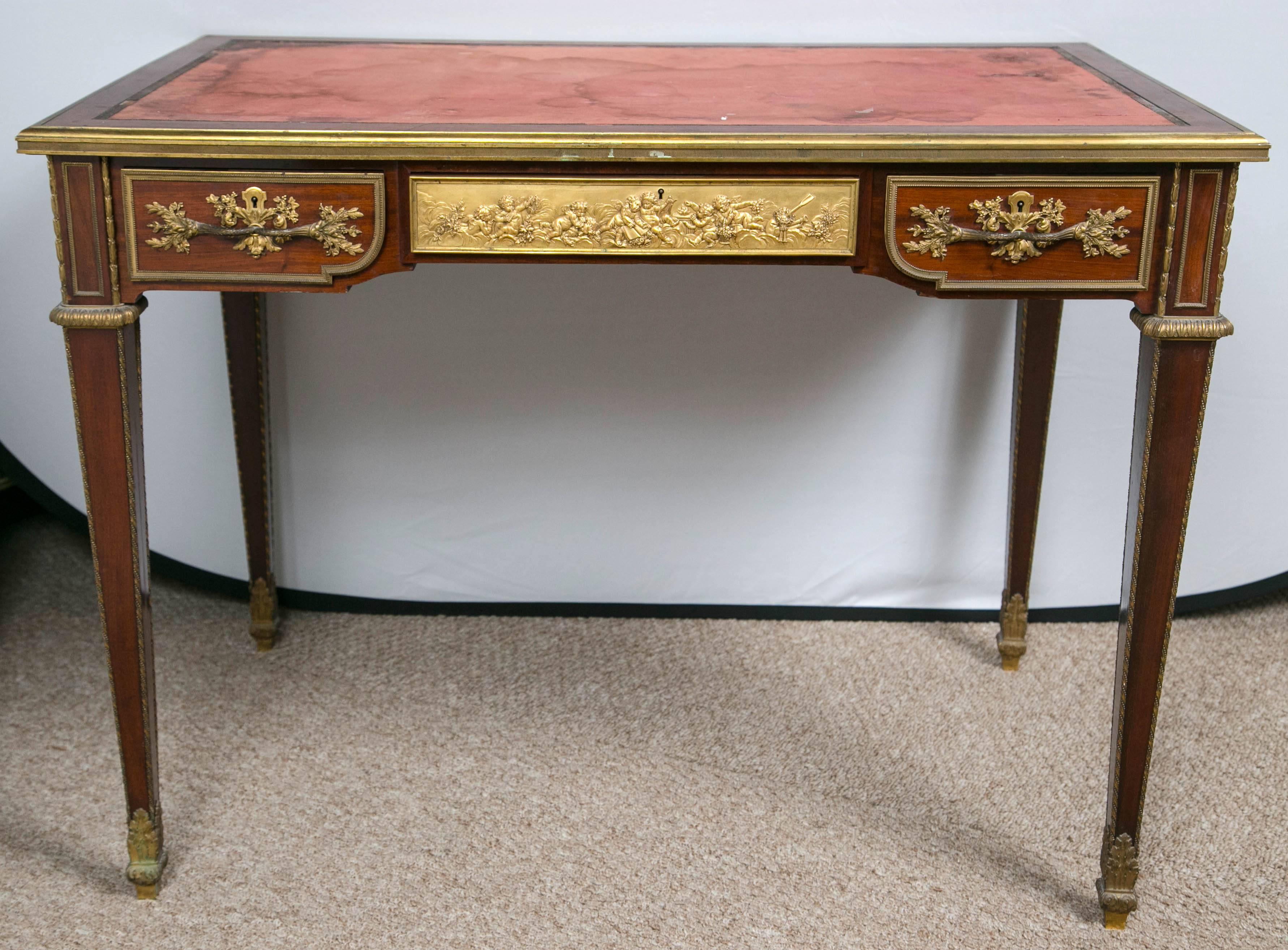 A French ormolu-mounted mahogany bureau plat by Paul Sormani. This finely detailed and signed late 19th century bureau plat has a fabric lined top above three frieze drawers, with false drawers to reverse, the lock plate signed P. Sormani Paris/10r