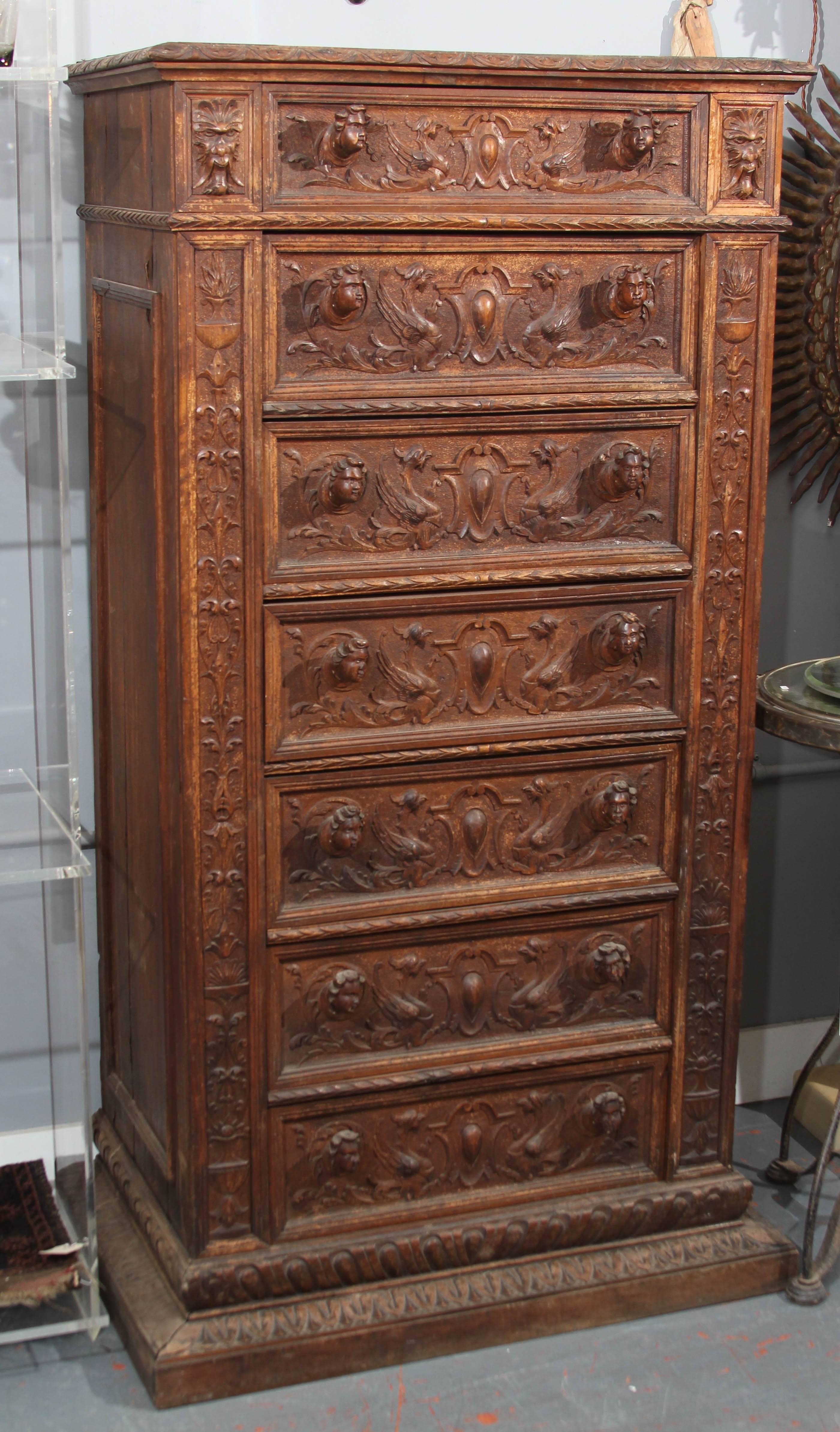 Carved highboy, tall chest with seven drawers. Very interesting piece of Folk Art with ample storage. Likely Italian.